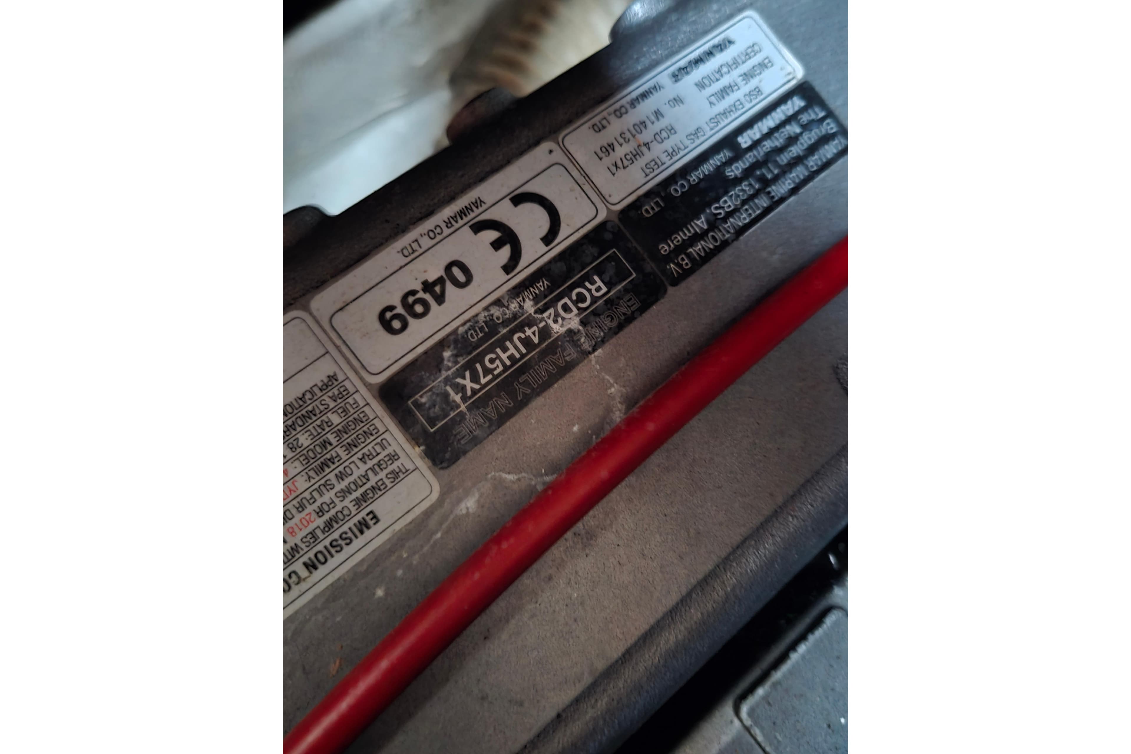 Close-up of a Pearson 365 Sloop 1980 engine label with red cable.