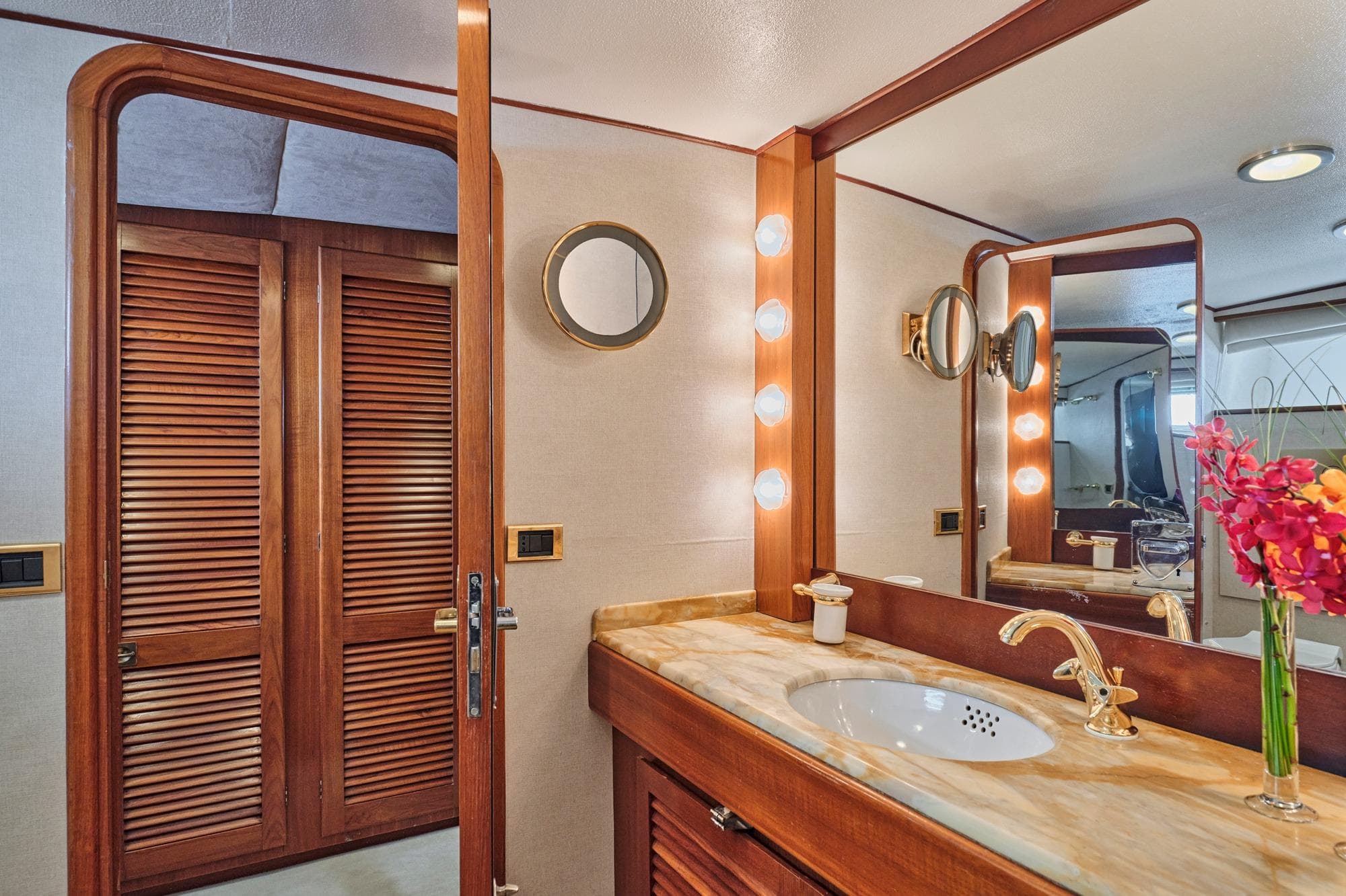 Luxurious yacht bathroom with wooden accents, marble countertop, and elegant lighting, CRN 60, 1975.