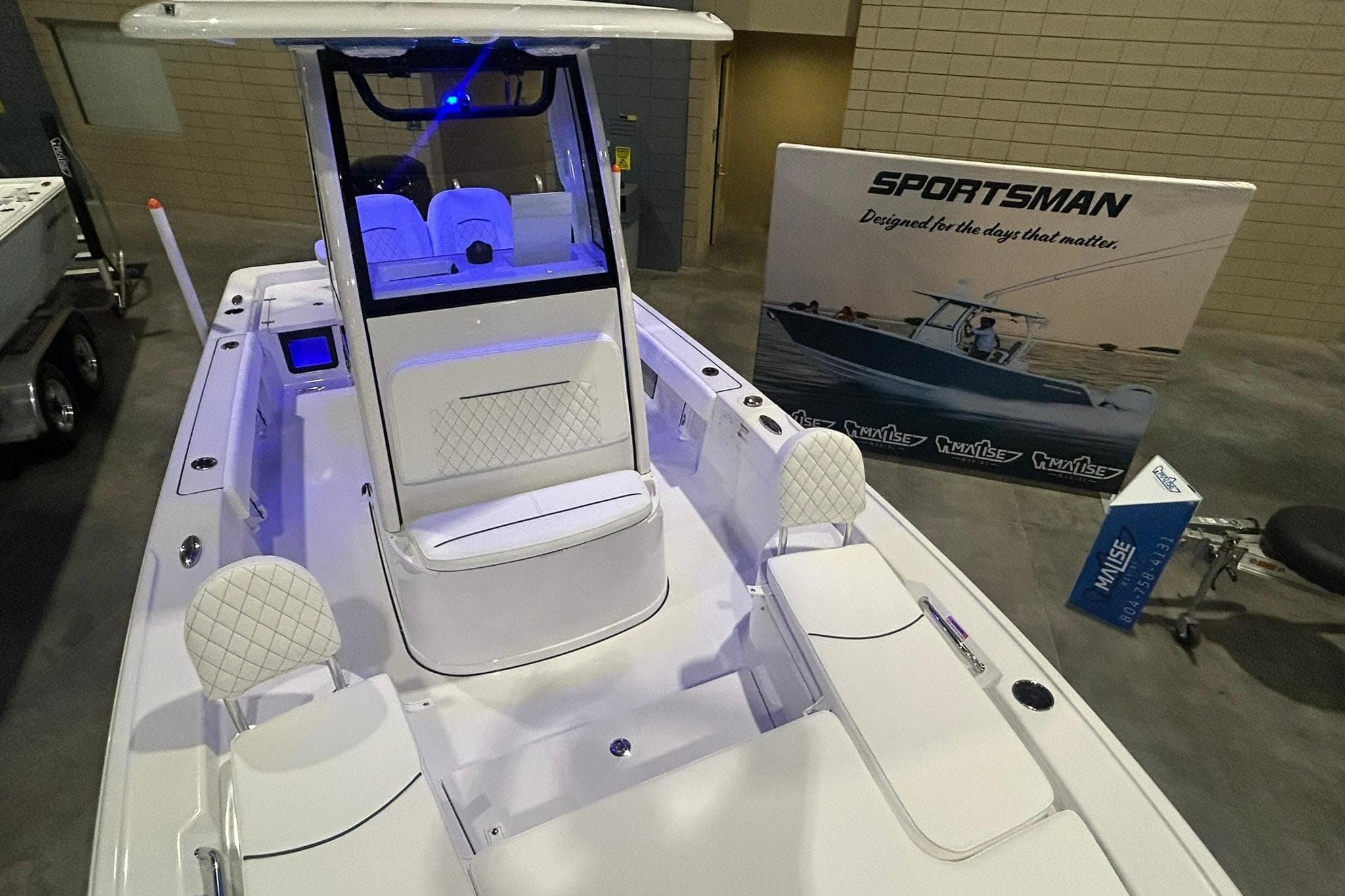 2026 Sportsman Masters 227 Bay Boat displayed indoors with promotional banner.