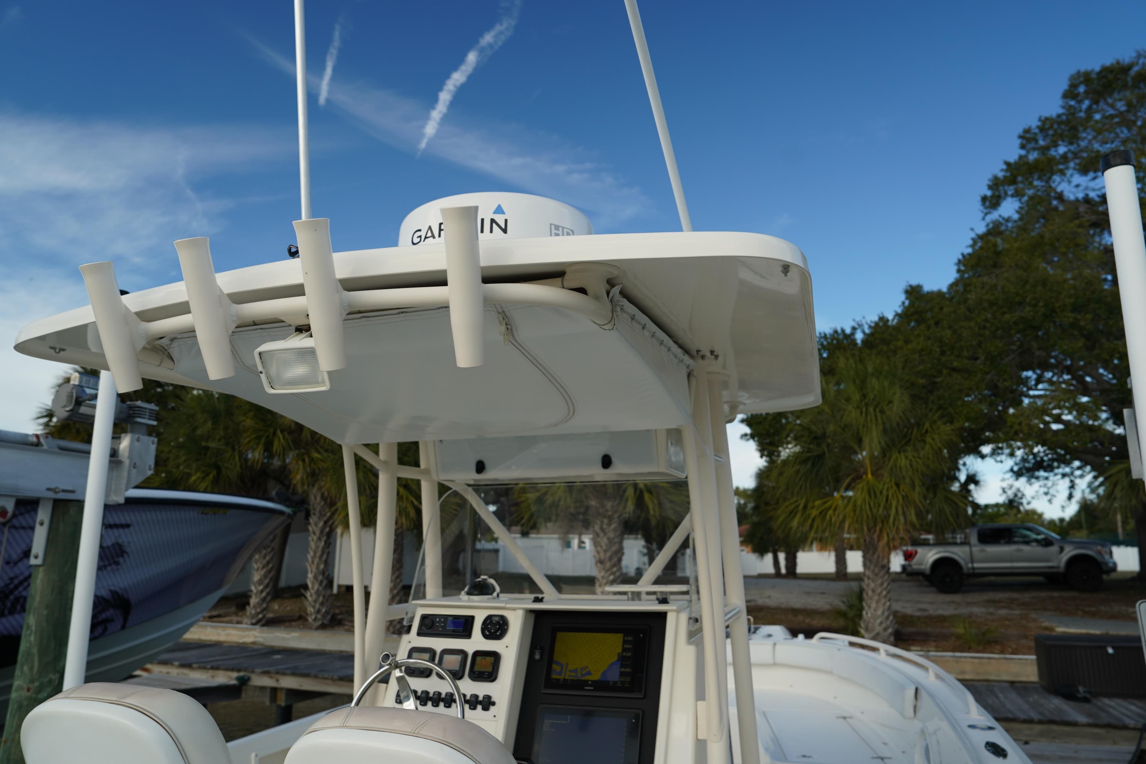 2013 Stamas 317 Tarpon boat with Garmin equipment, docked under a clear blue sky.