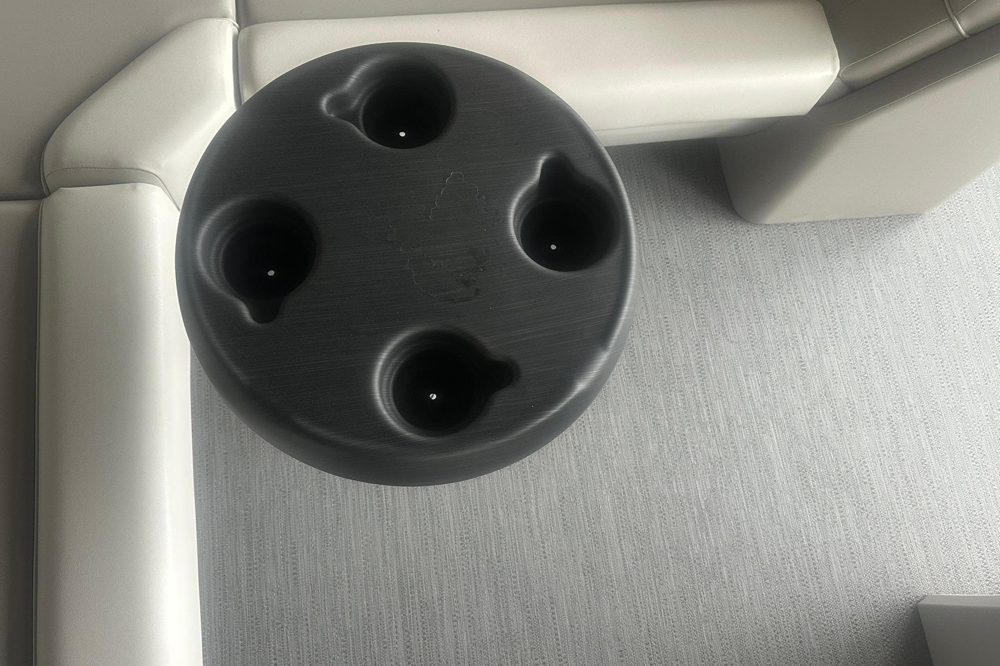 Round black cup holder on Sweetwater 2286FX boat, 2026 model, with beige seating.
