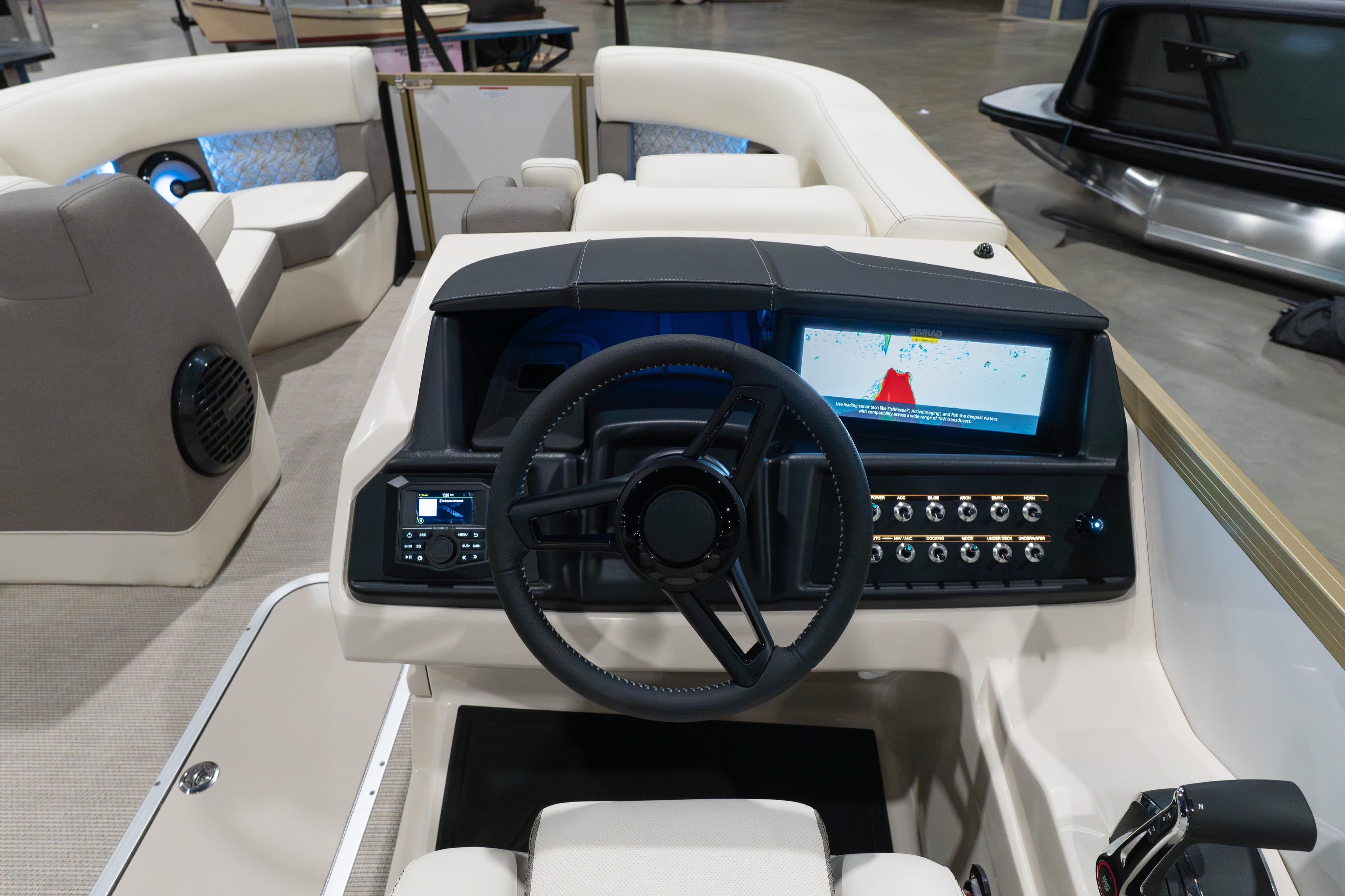Interior view of 2026 Alera M23Q boat dashboard with steering wheel and digital display.