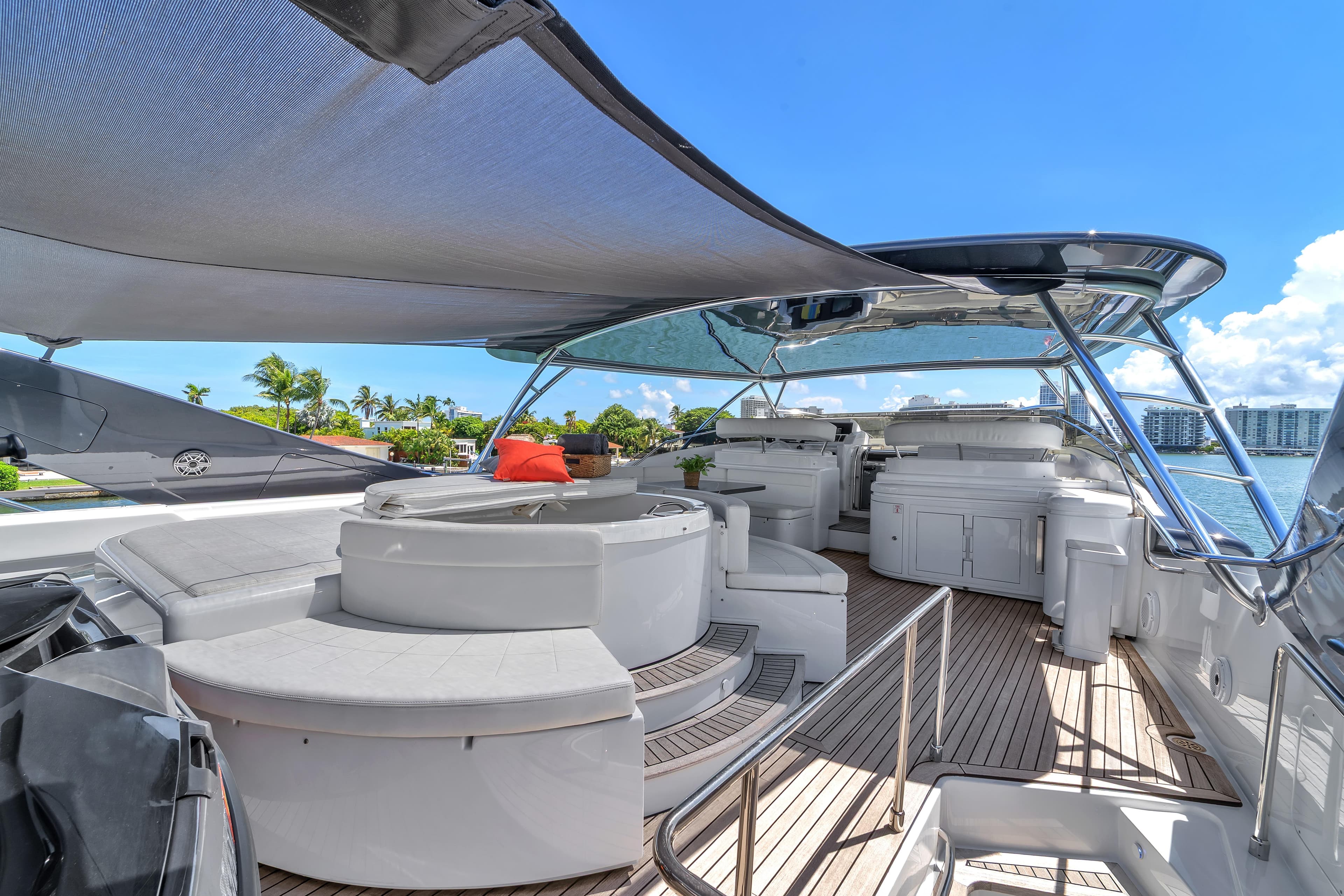 Luxurious 2002 Ferretti Yachts Custom Line 94 deck with seating, canopy, and ocean view.