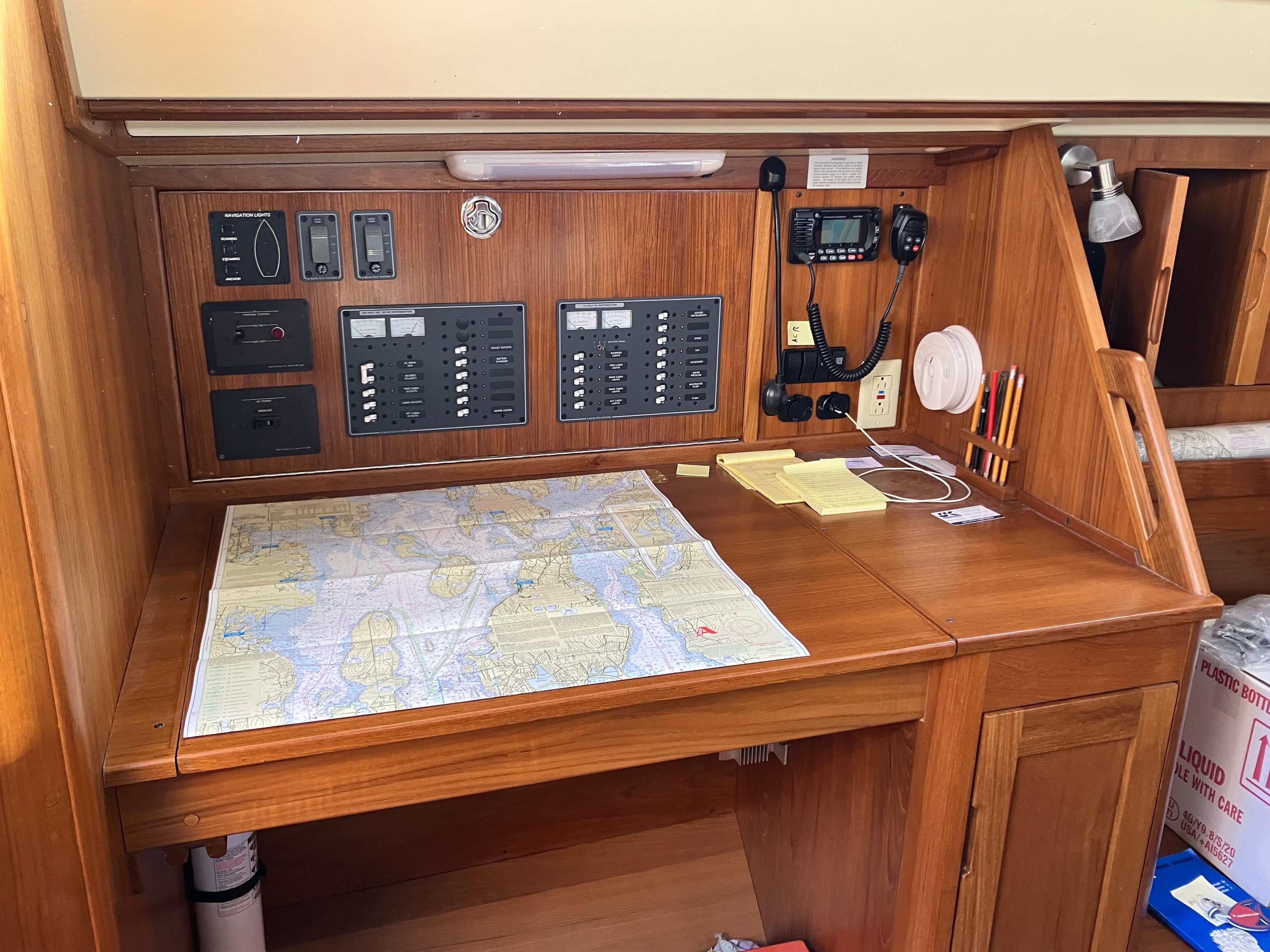 Navigation station on 1989 Pearson 39-2 sailboat with map and control panels.
