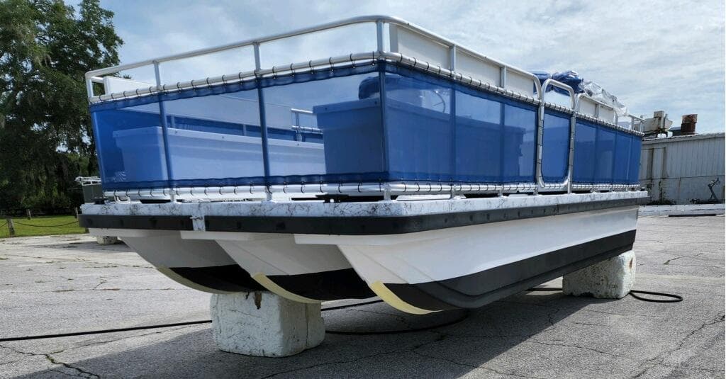 2025 A&M Manufacturing Salty 23 pontoon boat on display outdoors.