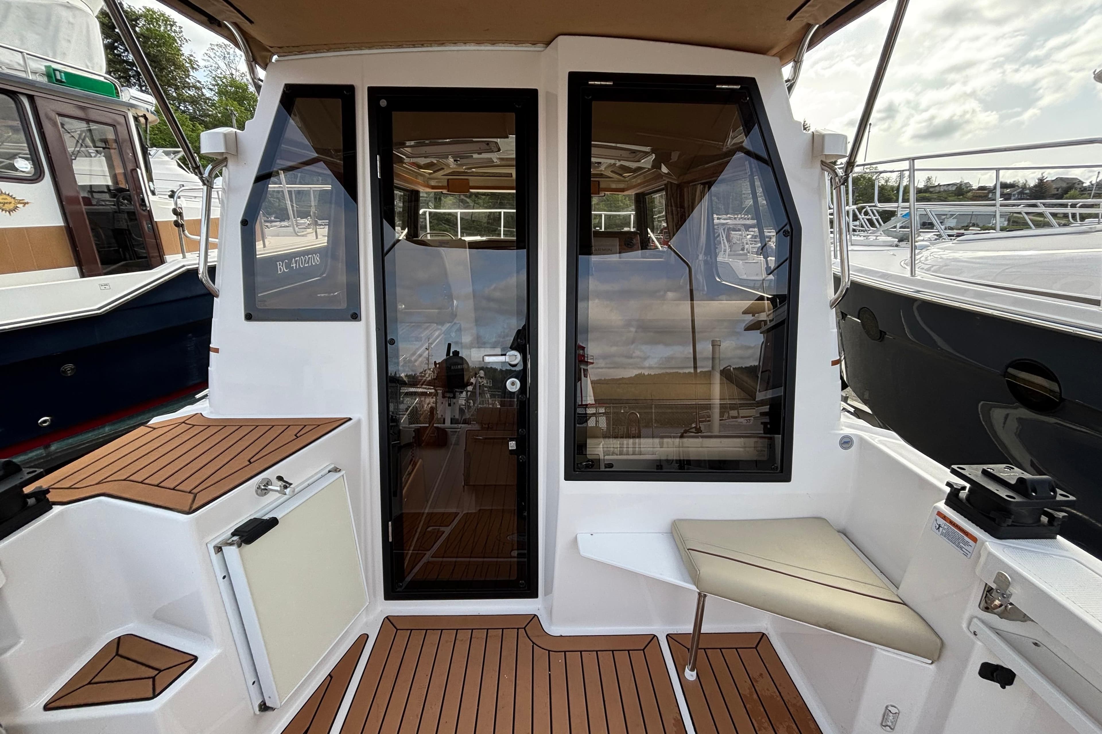 2022 Ranger Tugs R-27 boat cockpit with teak flooring and seating area.
