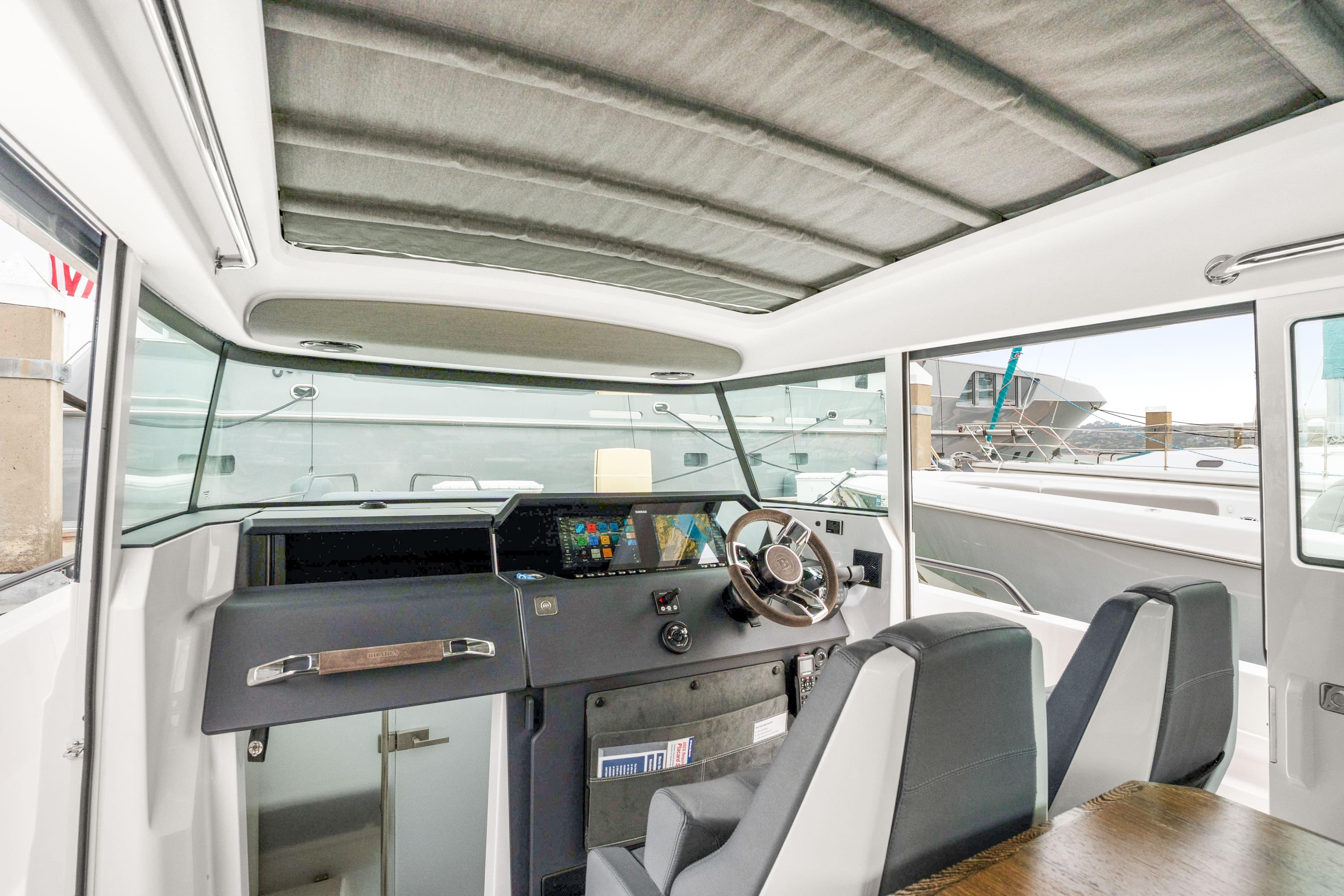 Interior of 2021 Axopar 37 XC Cross Cabin with modern helm and seating.