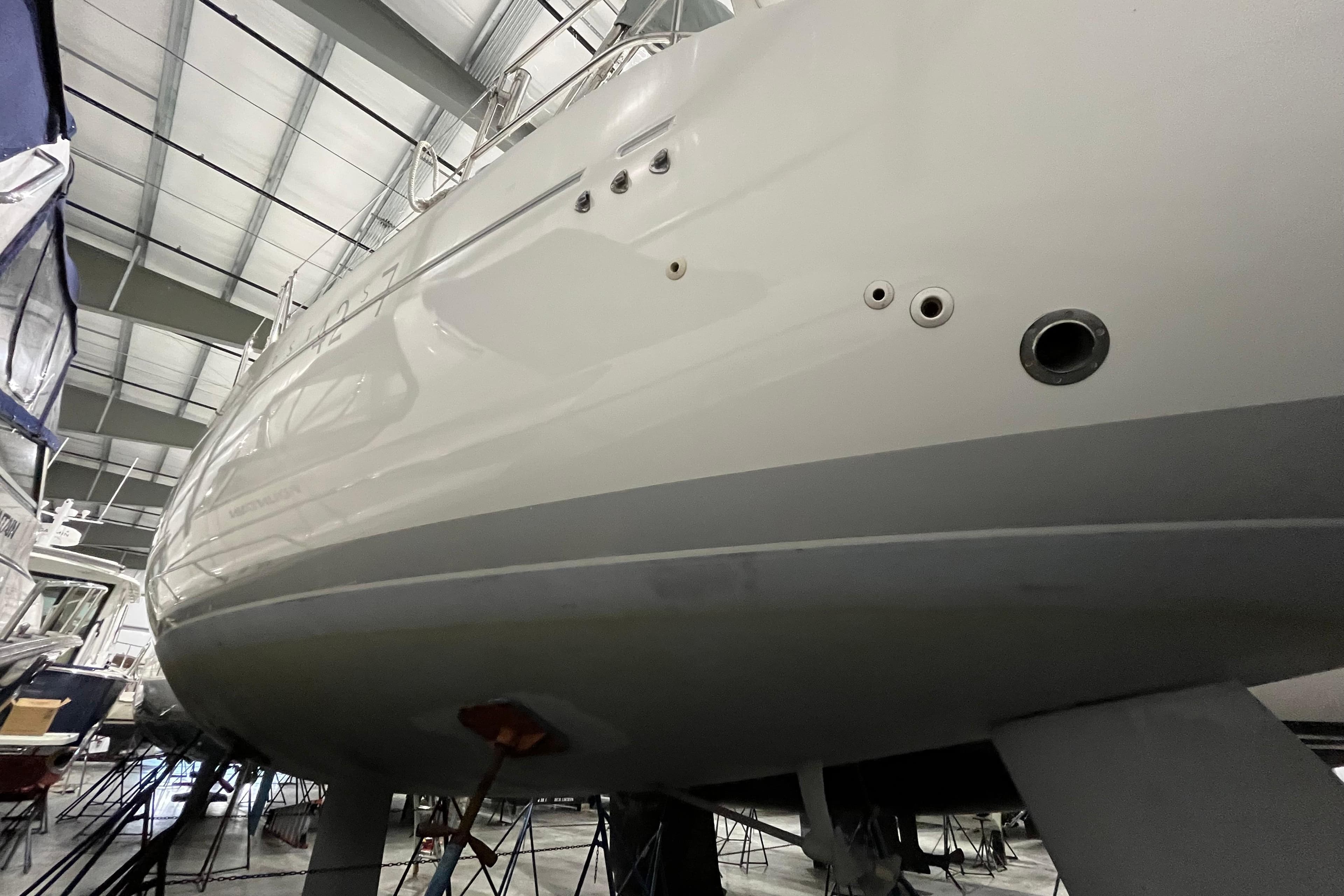 1999 Beneteau First 42s7 sailboat in dry dock, showcasing sleek hull design.