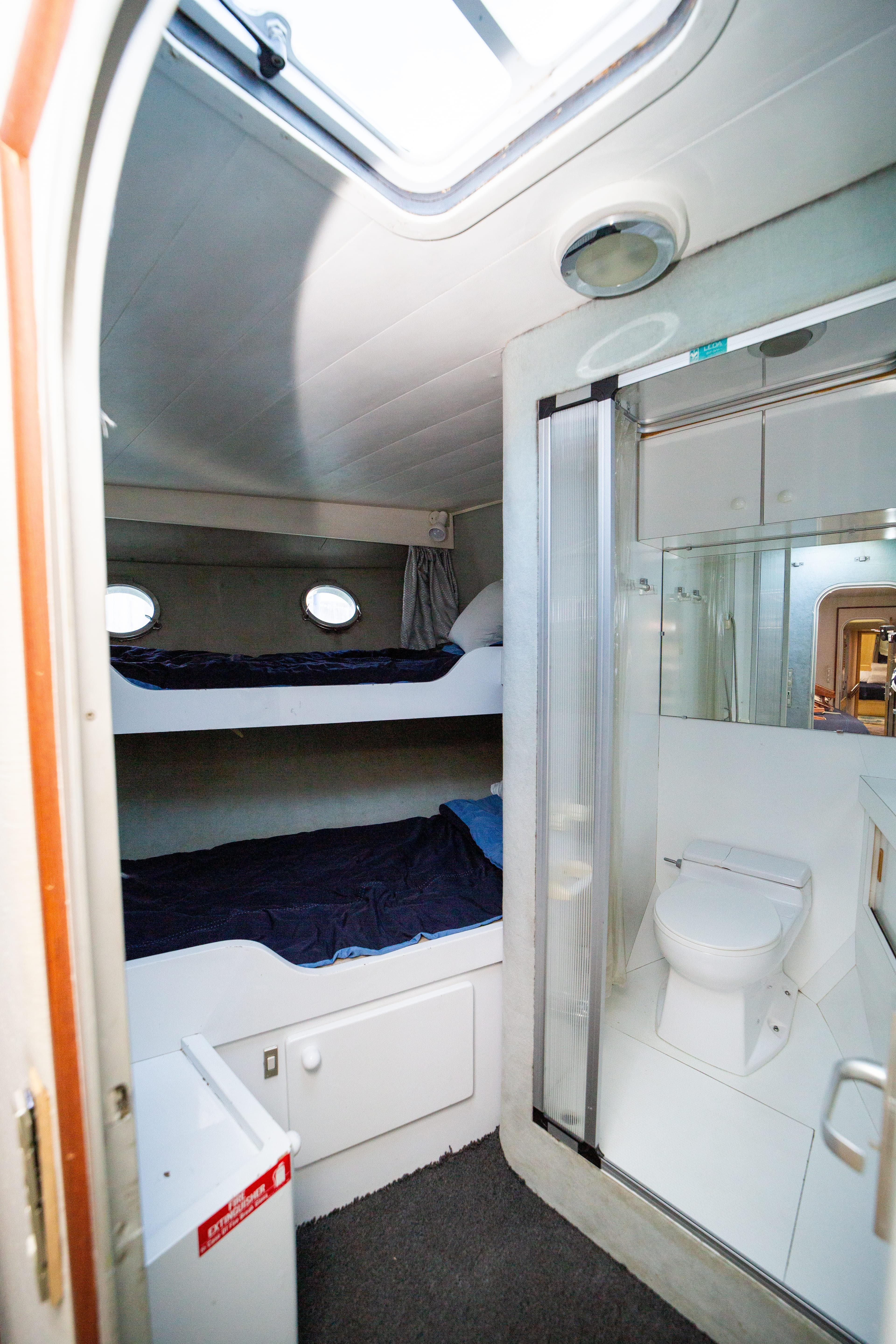 Interior of 1987 Guy Couach 97 yacht with bunk beds and bathroom.