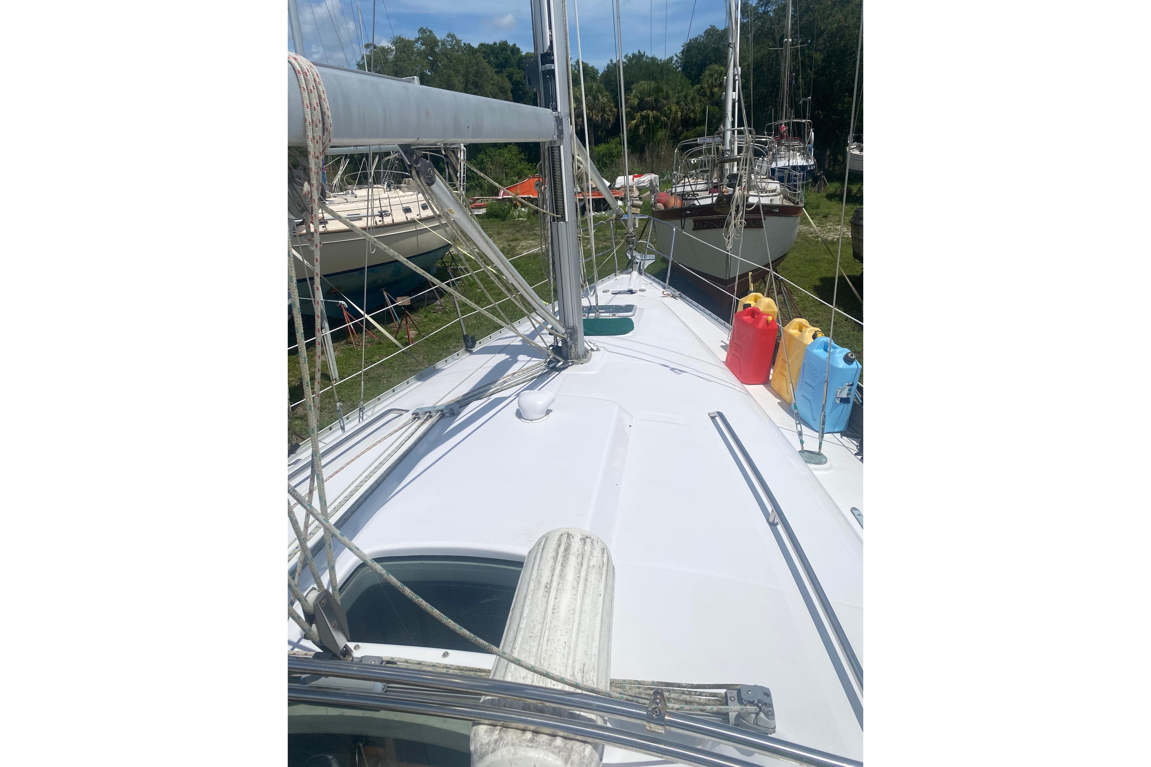 2002 Beneteau Oceanis Clipper 361 sailboat deck with colorful fuel containers.