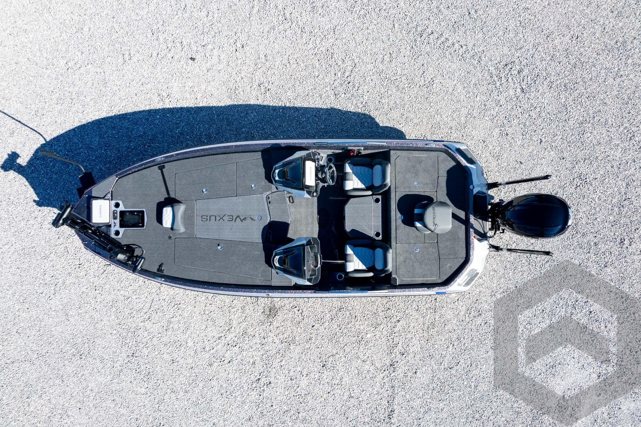 Aerial view of 2026 Vexus VXs21 fishing boat on gravel surface.