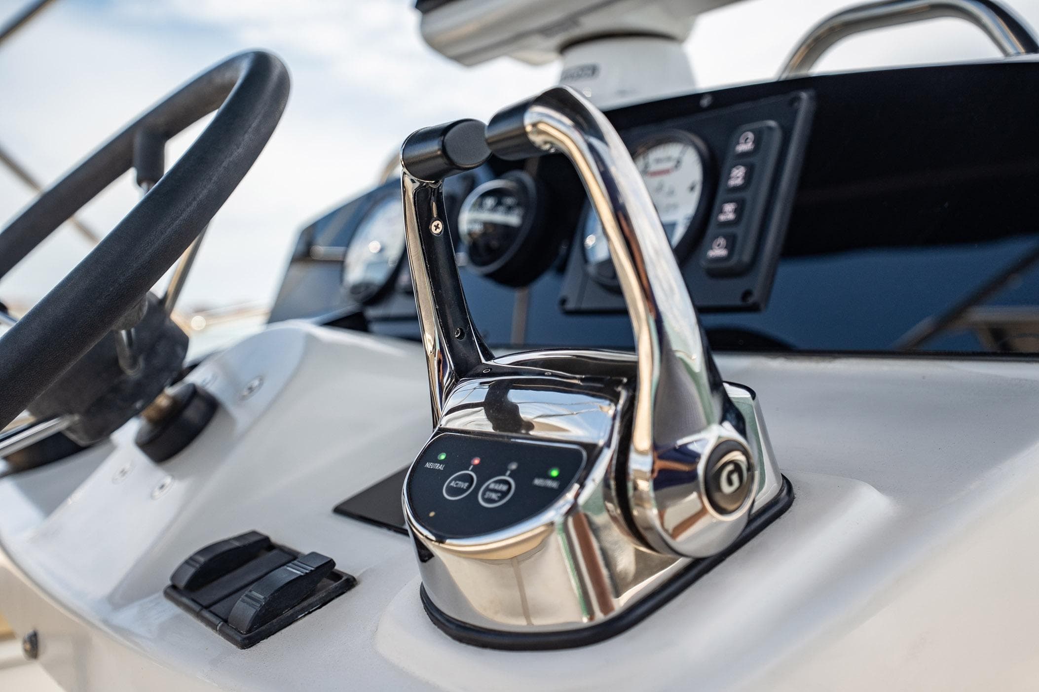 Close-up of 2005 Lagoon Power 43 yacht controls and steering wheel.