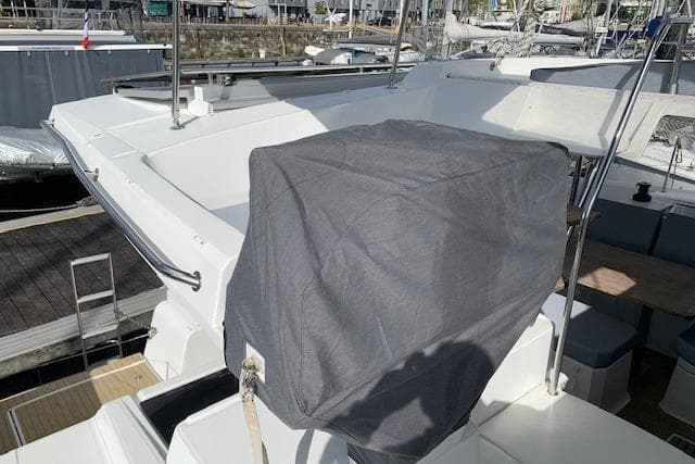 2020 Fountaine Pajot Astrea 42 yacht deck with covered equipment, docked at marina.