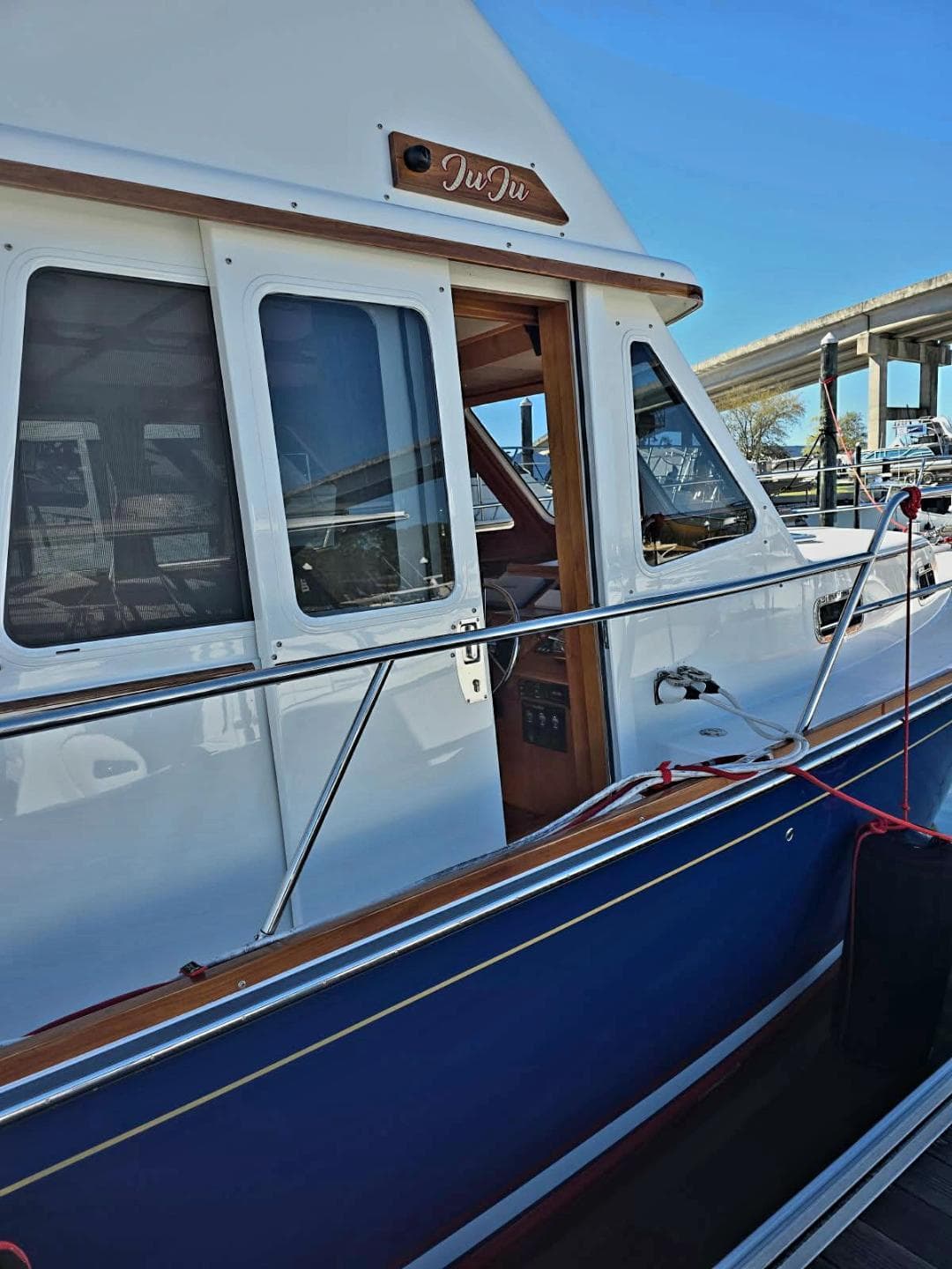 2004 Sabre 36 Flybridge Fast Trawler, side view with windows and railing.