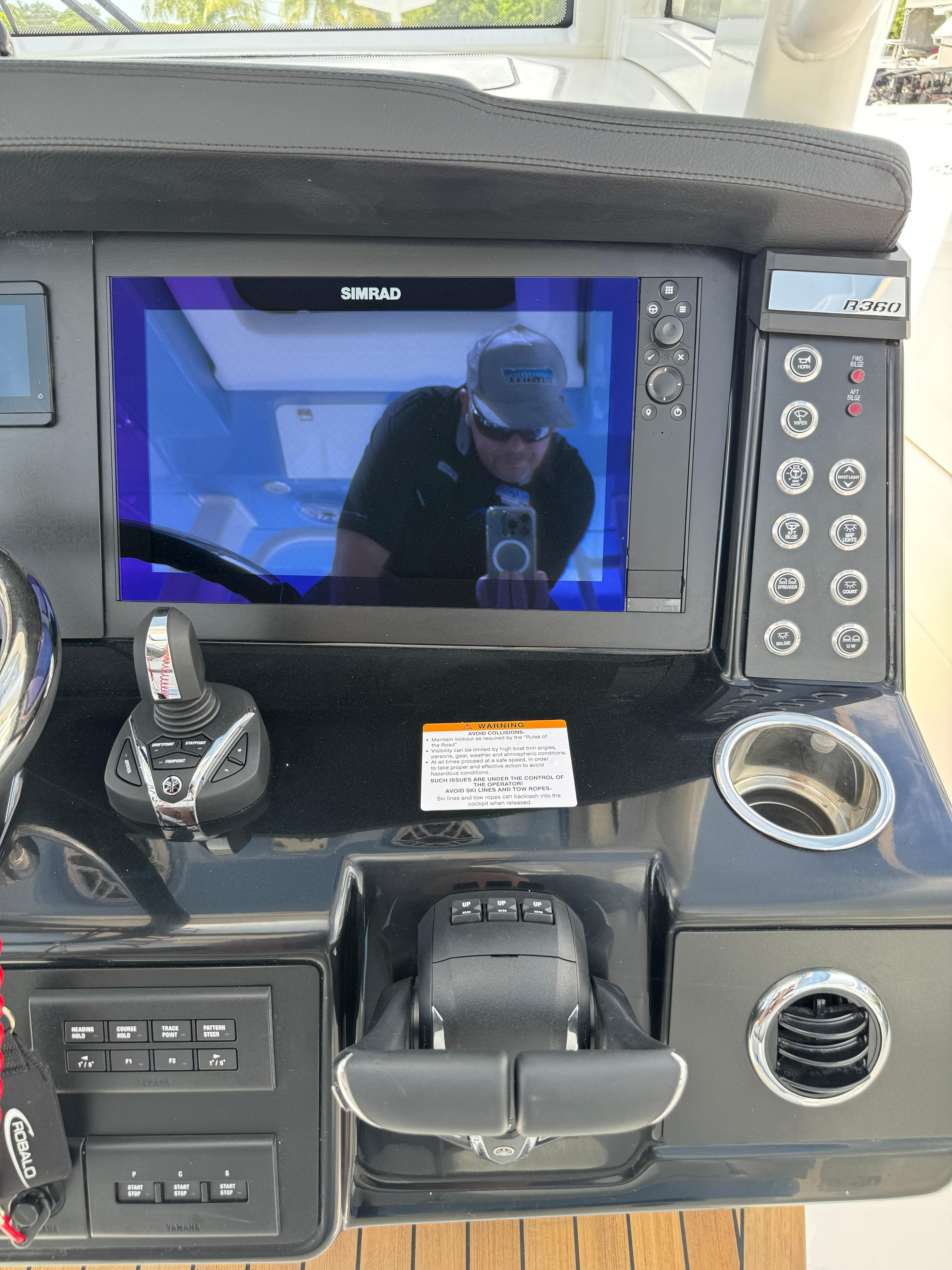 2025 Robalo R360 Center Console dashboard with Simrad display and control panel.