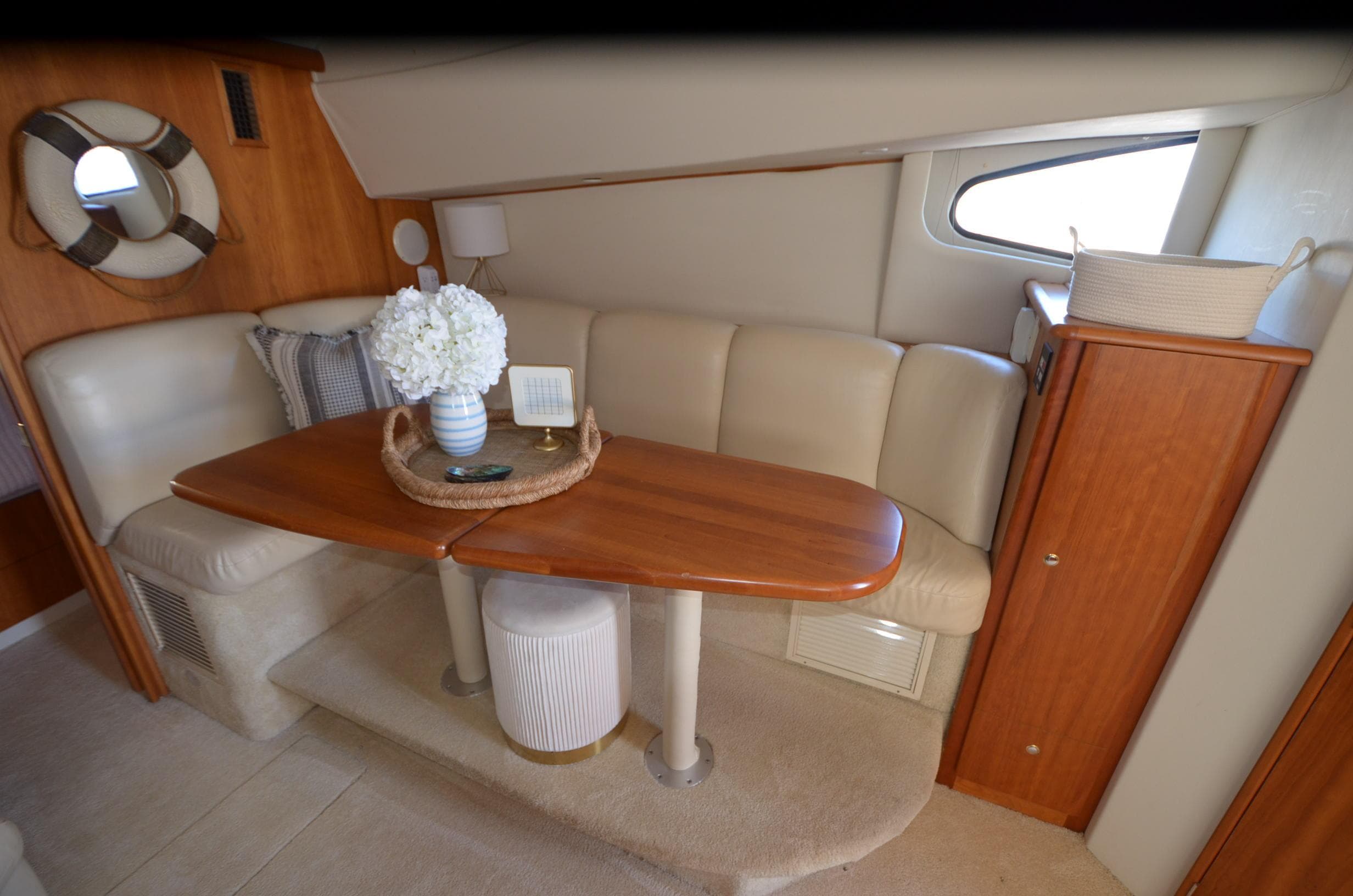 Interior of 2000 Silverton 330 Sport Bridge with cozy seating and wooden table.