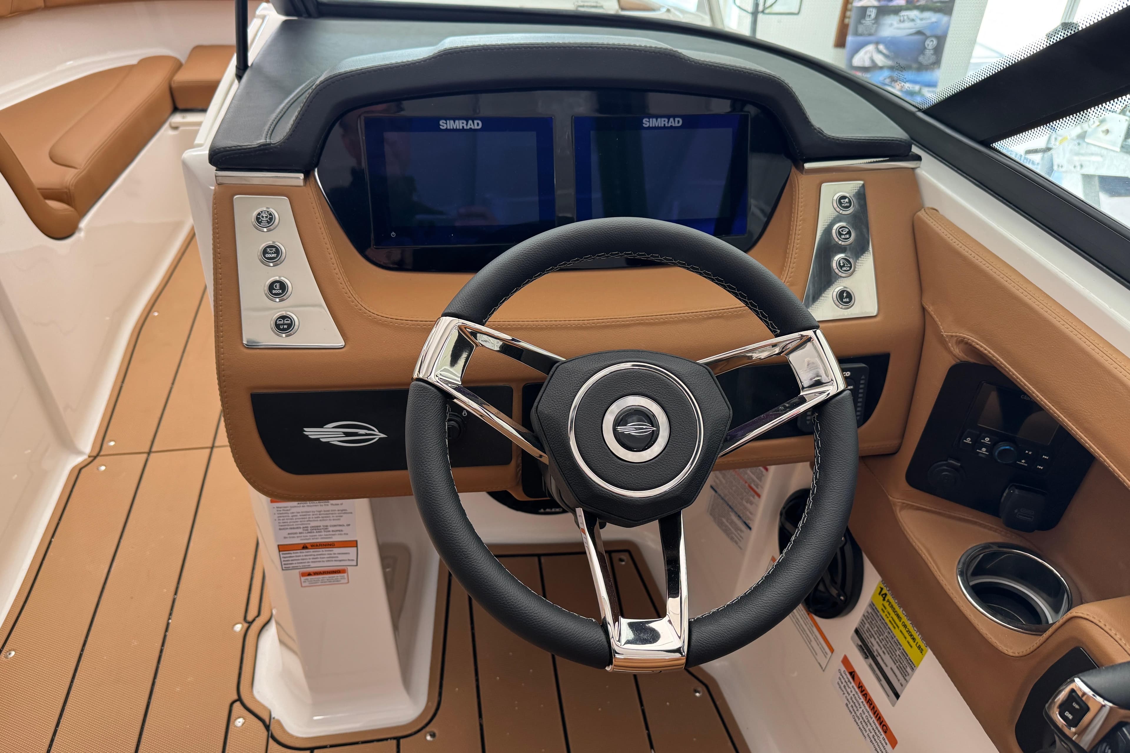 2026 Chaparral 250 OSX boat dashboard with steering wheel and Simrad displays.