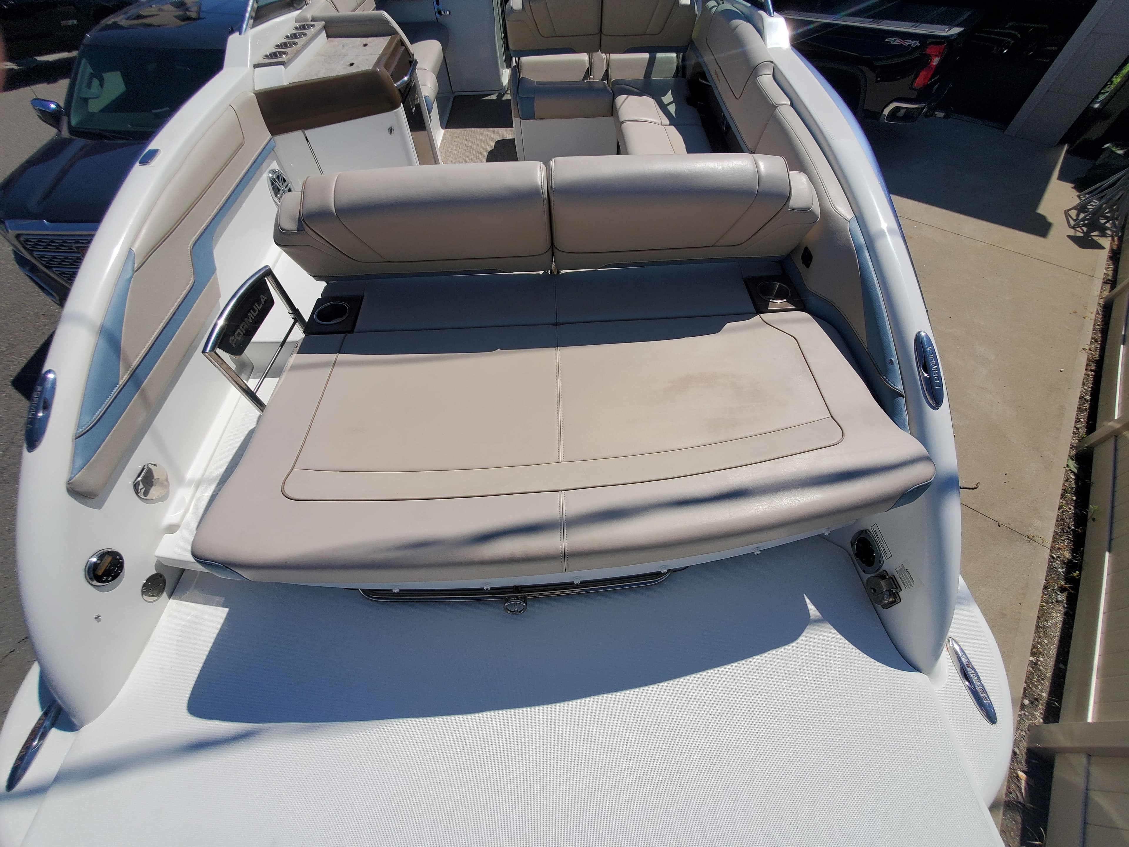 2018 Formula 310 Bowrider boat interior with beige seating and sun pad.