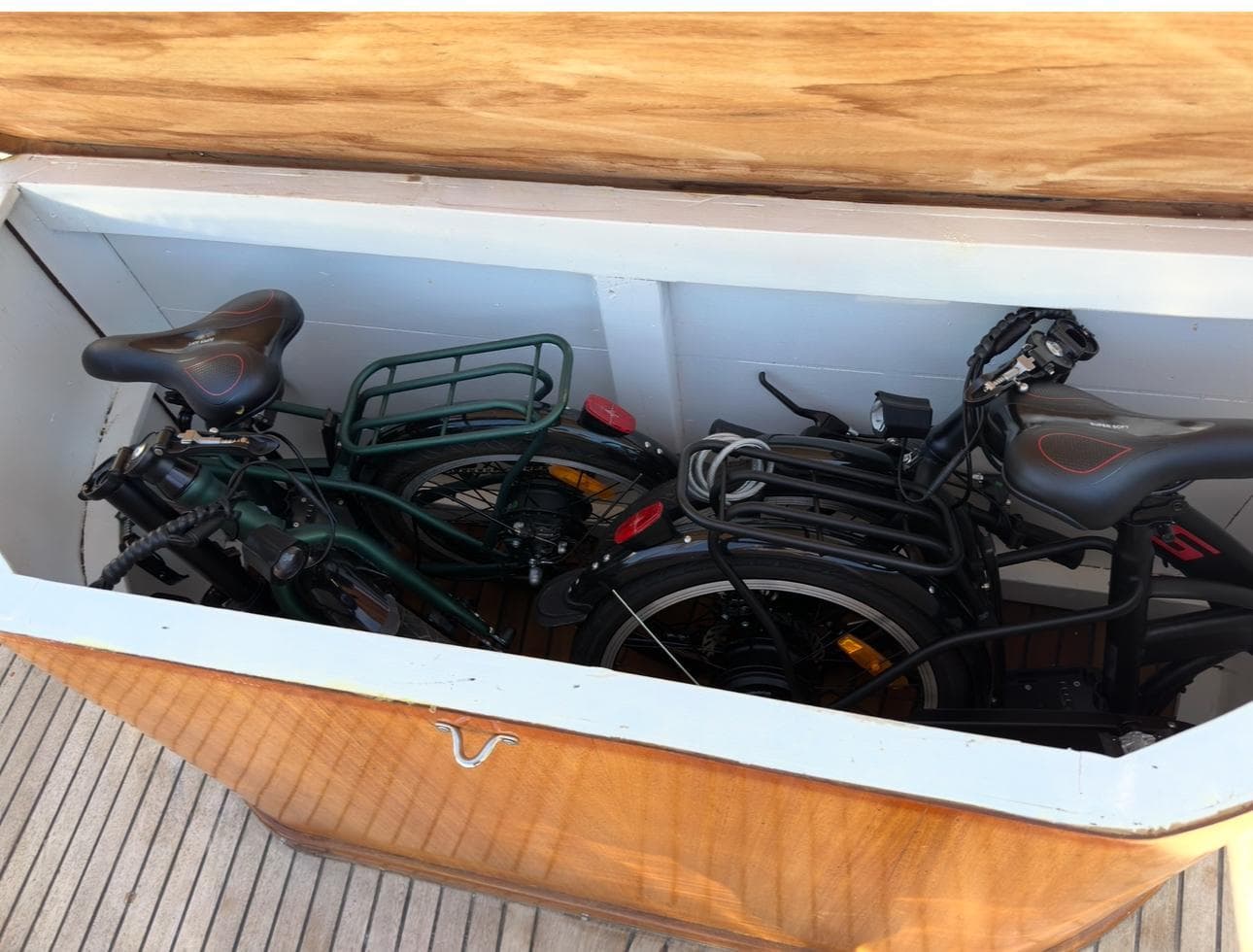 Two bicycles stored in a wooden compartment on a 1994 Custom ABATS Gulet Ketch.