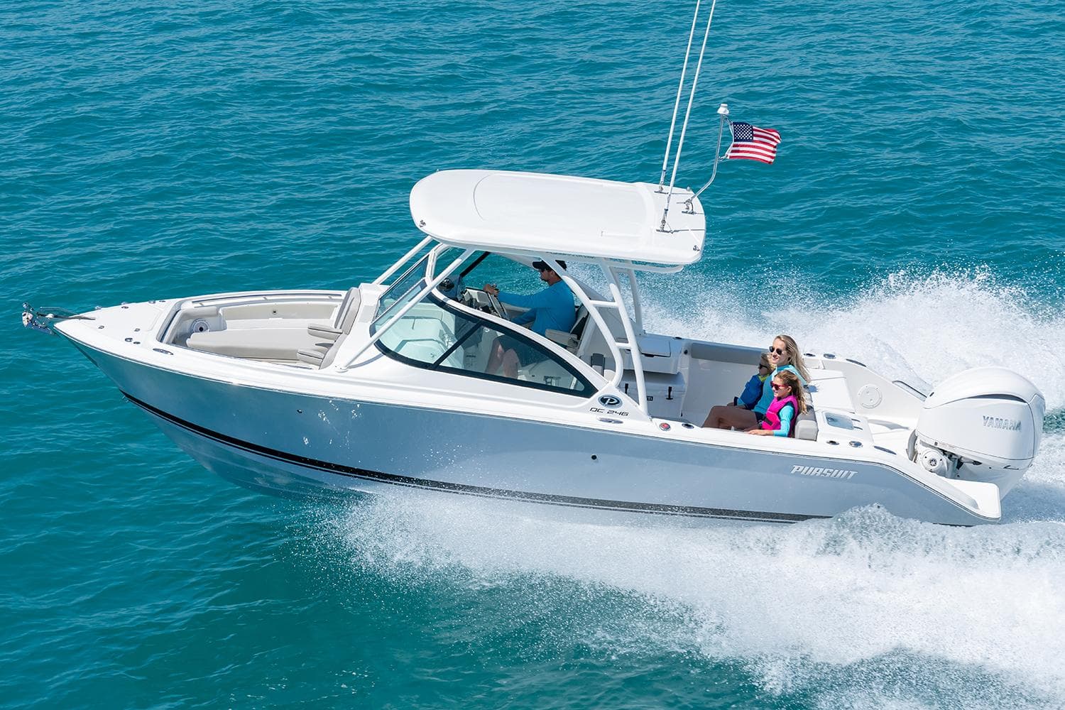 Manufacturer Provided Image: 2025 Pursuit DC 246 Dual Console boat cruising on clear blue water.