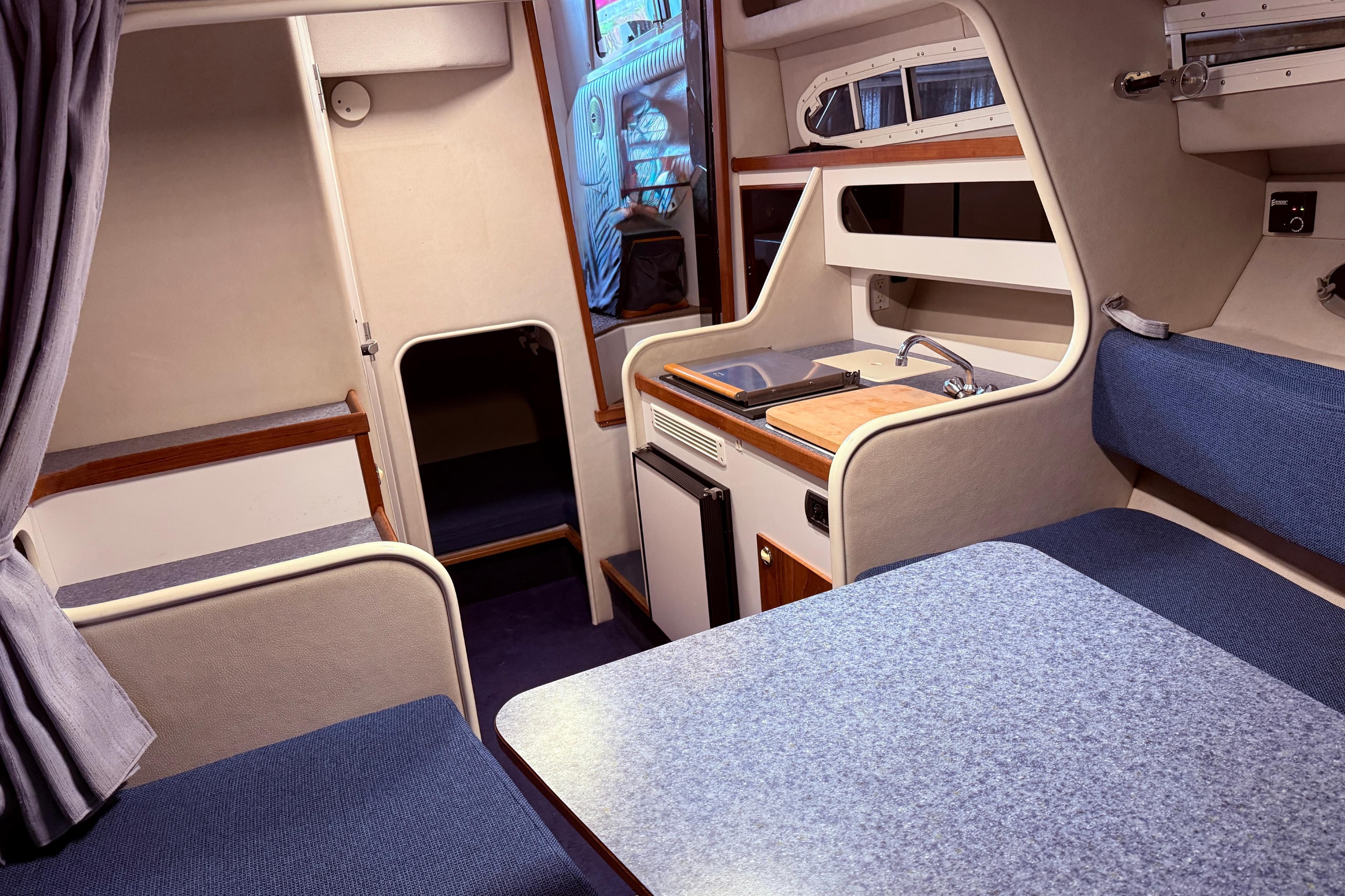 Interior of a 2006 Monaro 27 SE/SX boat with kitchenette and seating area.