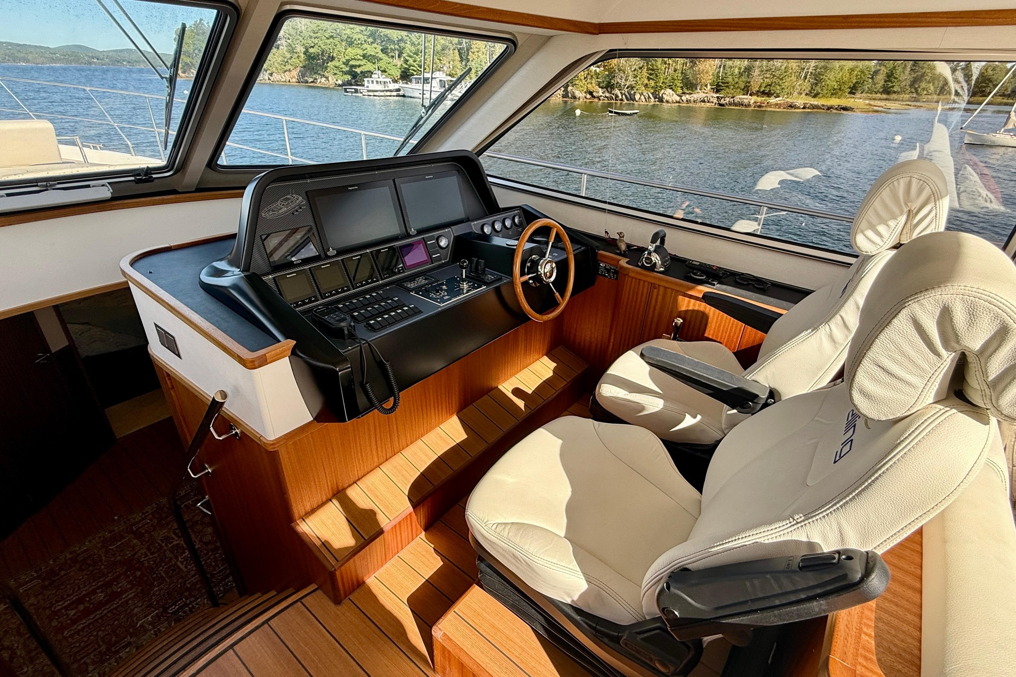Luxurious 2021 Elling E6 yacht interior with modern helm and plush seating.