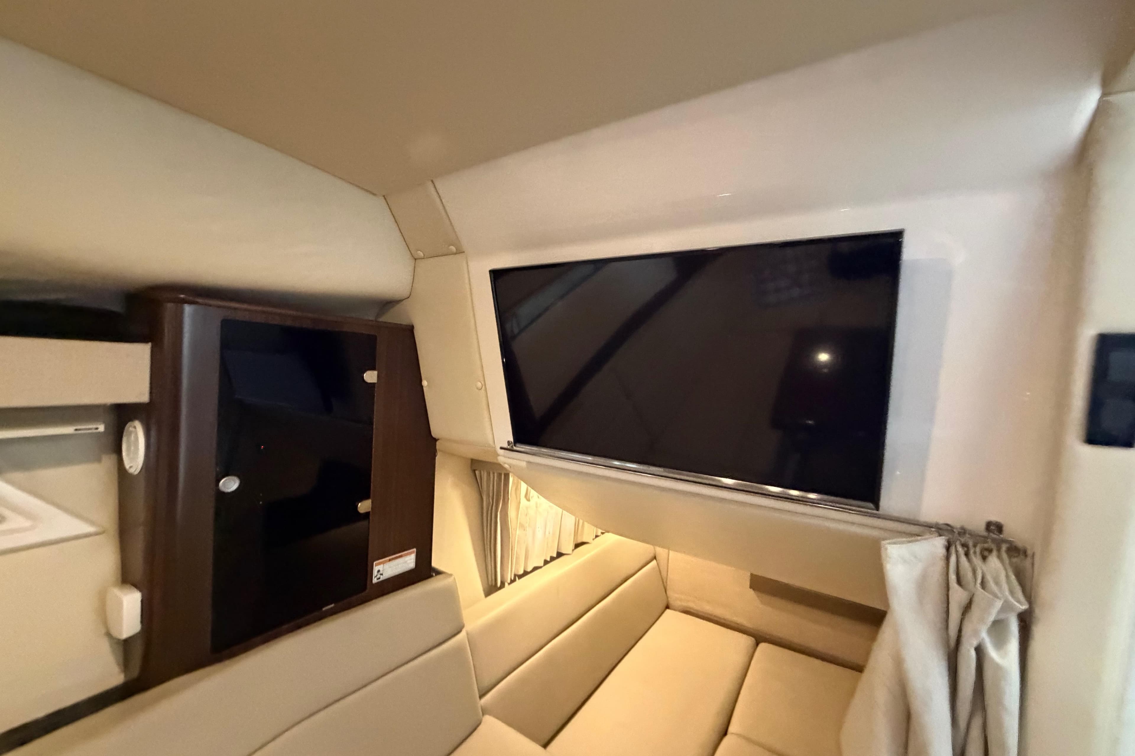 Interior of 2016 Regal 35 Sport Coupe with TV and seating area.