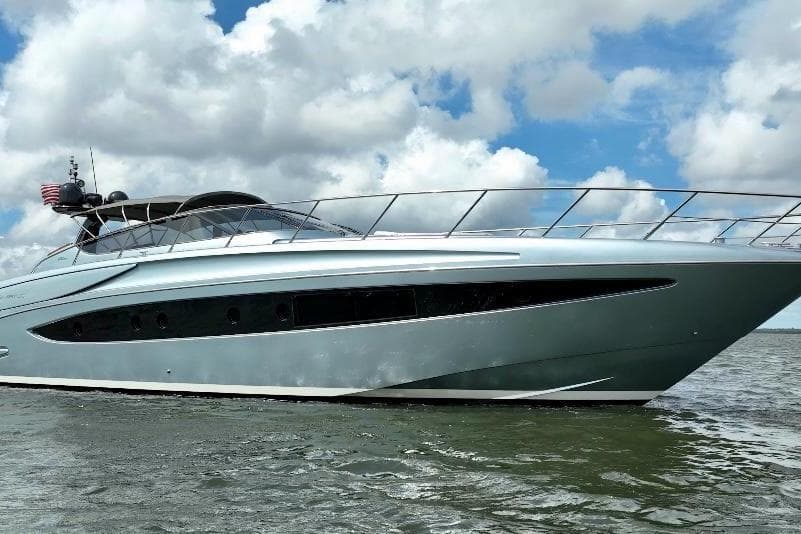 2016 Riva 63 Virtus yacht cruising on open water under a cloudy sky.