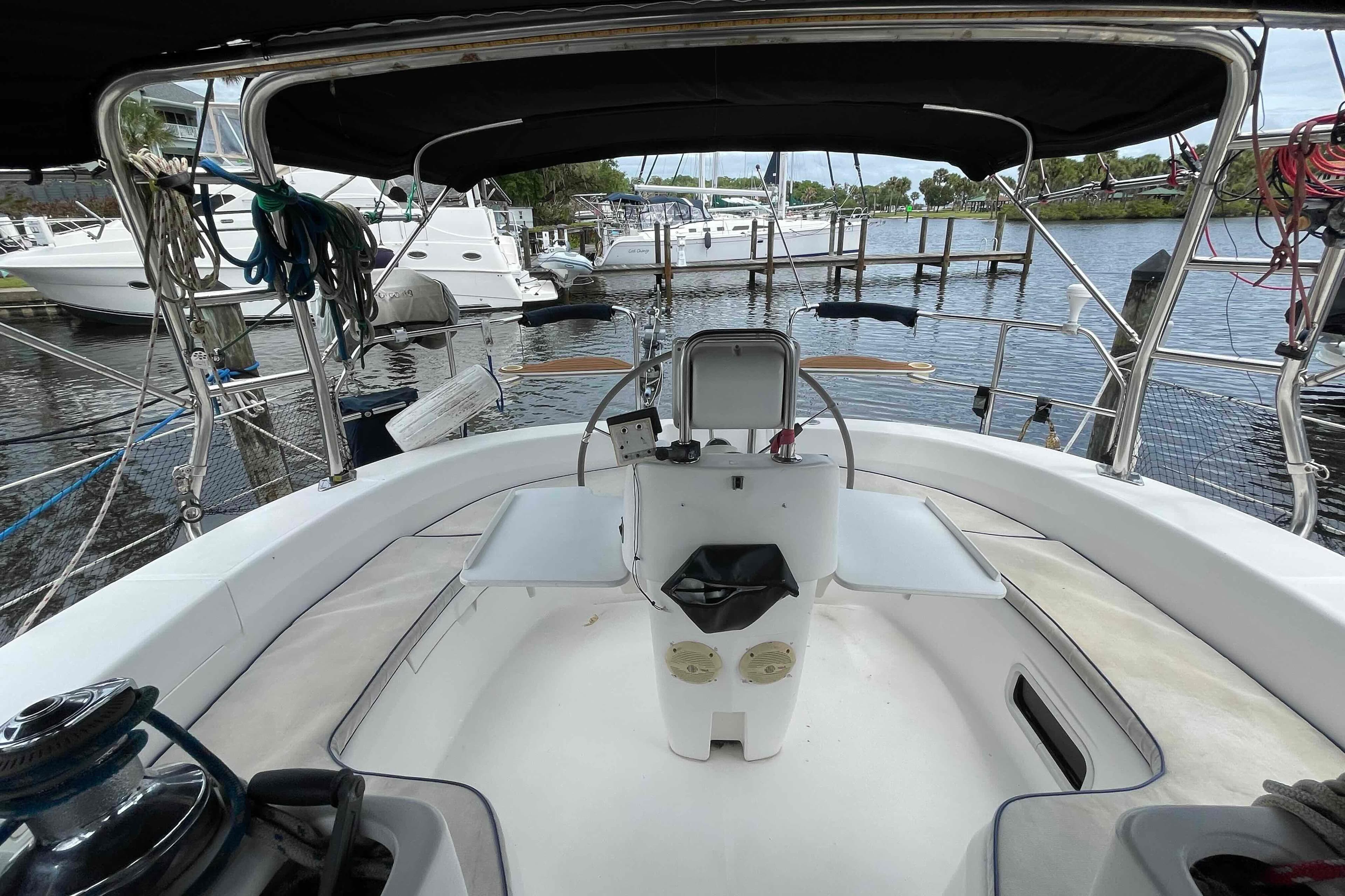 Cockpit view of a 2000 Hunter 410 sailboat docked at a marina.