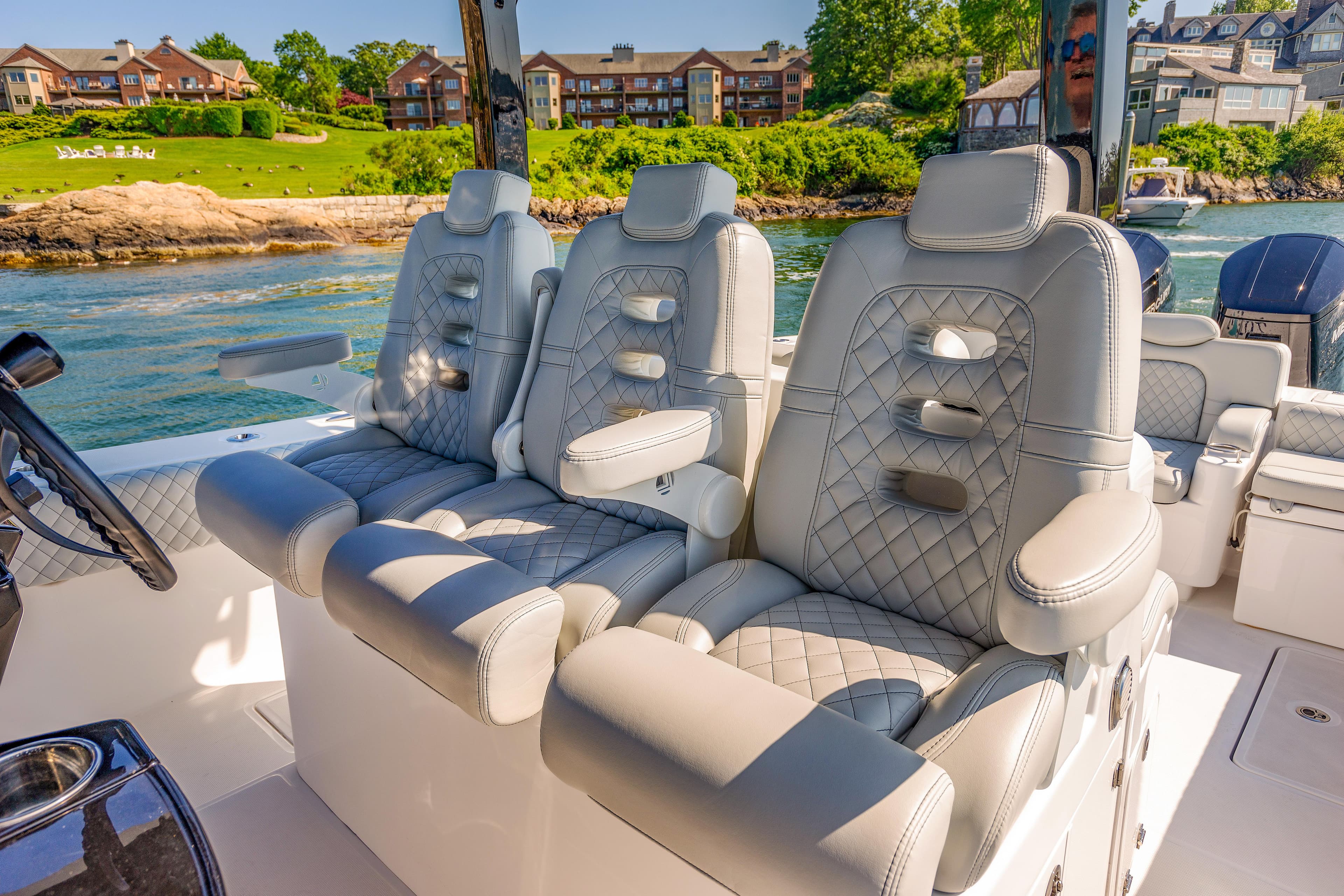 Luxurious seating on the 2024 HCB 39 Speciale boat with scenic waterfront view.
