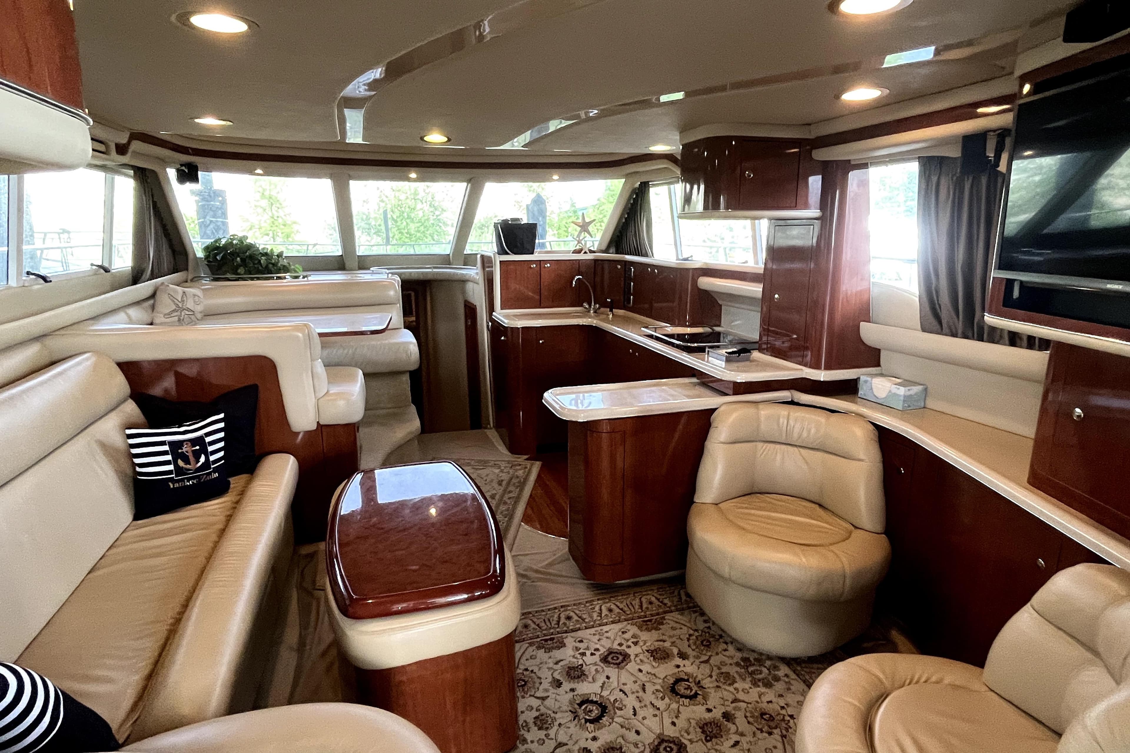 Luxurious interior of a 2003 Sea Ray 480 Sedan Bridge yacht with elegant seating and wood finishes.