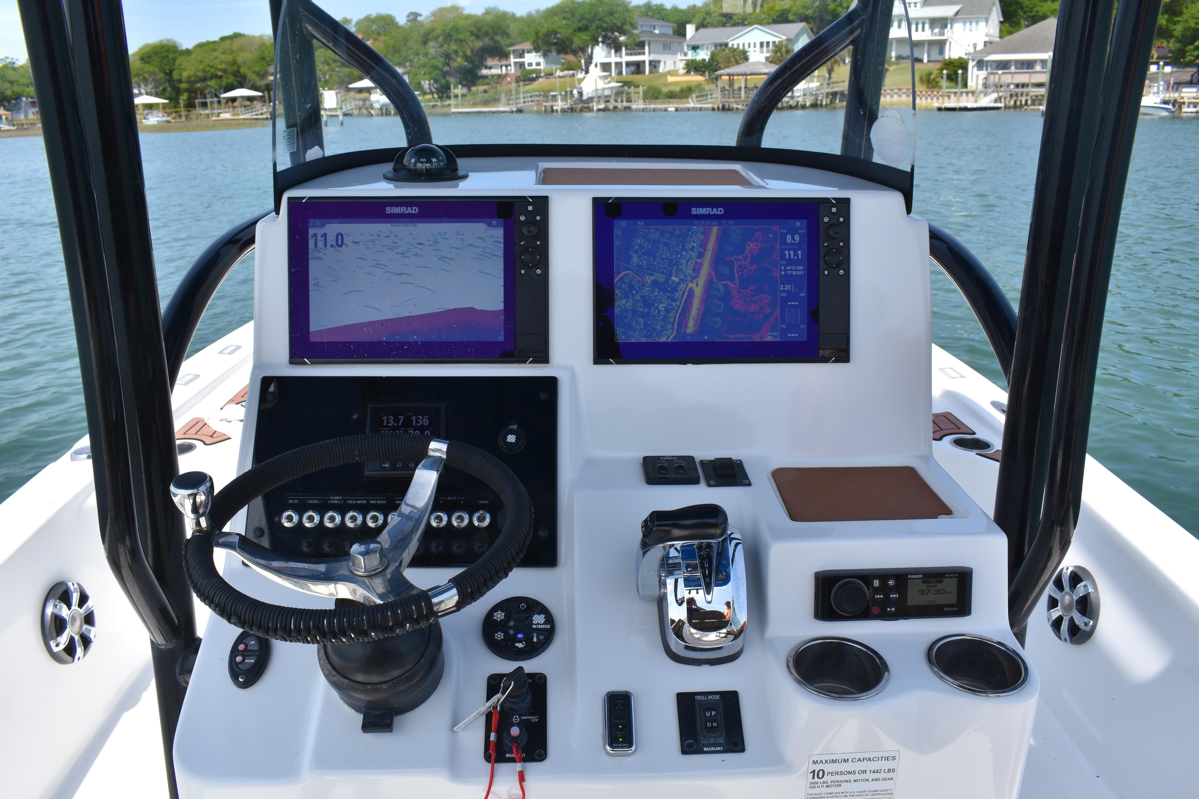 2018 Sea Pro 248 Bay boat dashboard with dual Simrad displays and steering wheel.