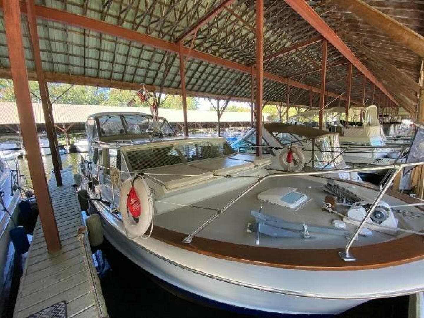 1970 Chris-Craft 42 Commander docked in a covered marina.