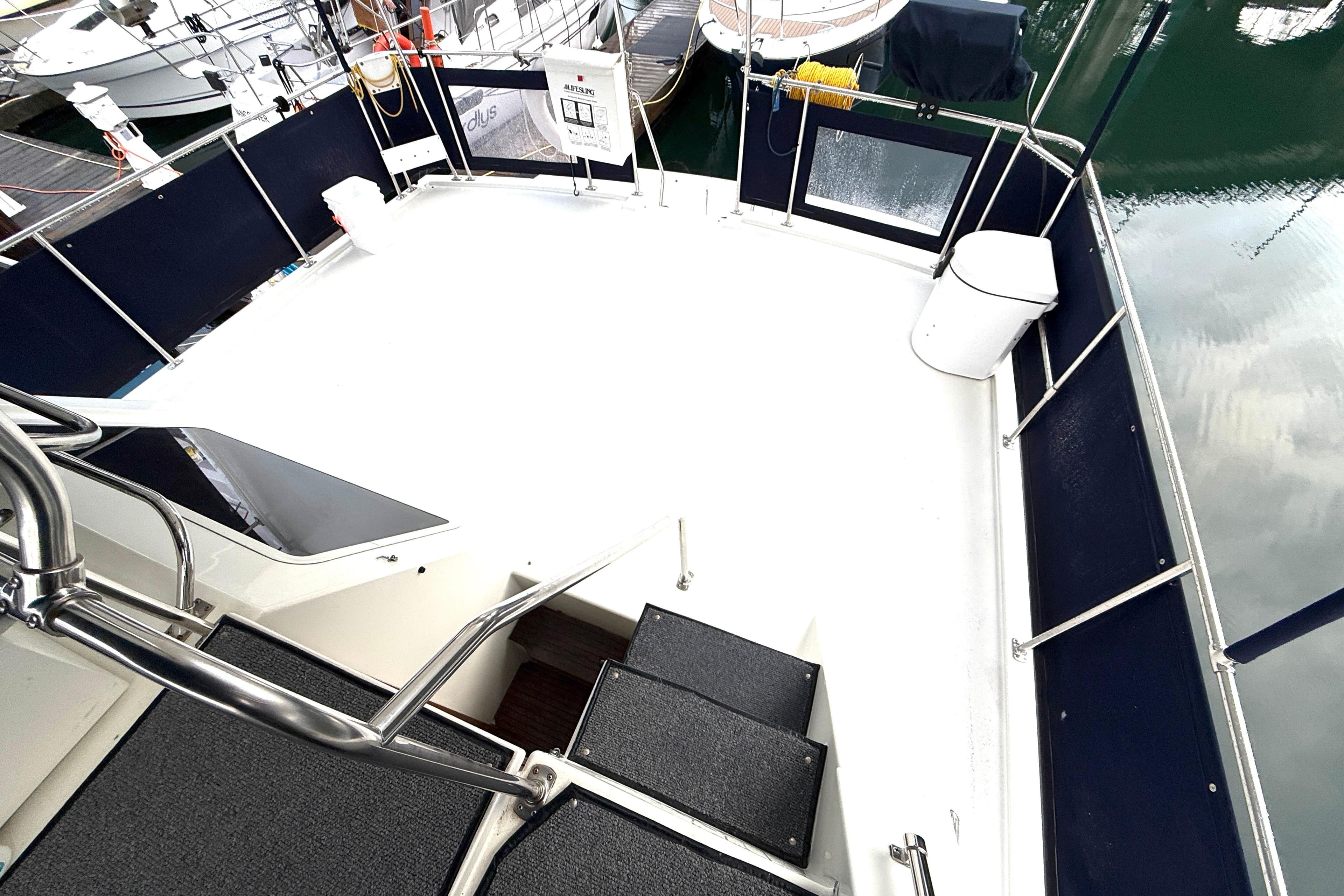 1994 Tollycraft 45 Cockpit Motor Yacht deck with railing and marina view.
