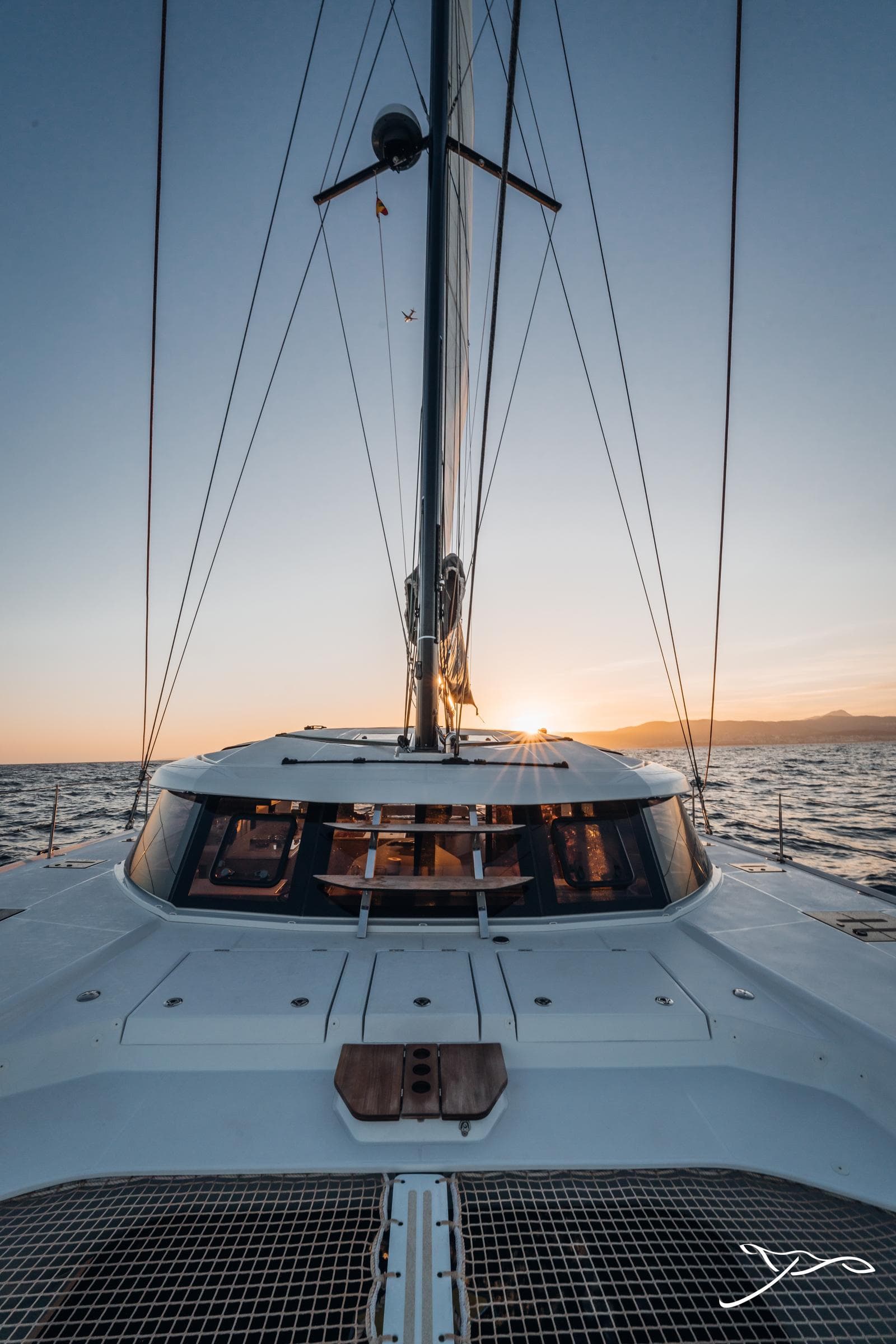2025 Nautitech 44 Open sailing at sunset, showcasing sleek design and ocean view.