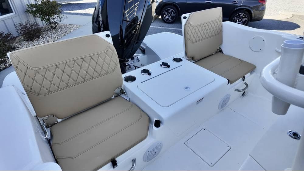 2025 Bayliner Trophy 22 CC boat interior with beige cushioned seats and center console.