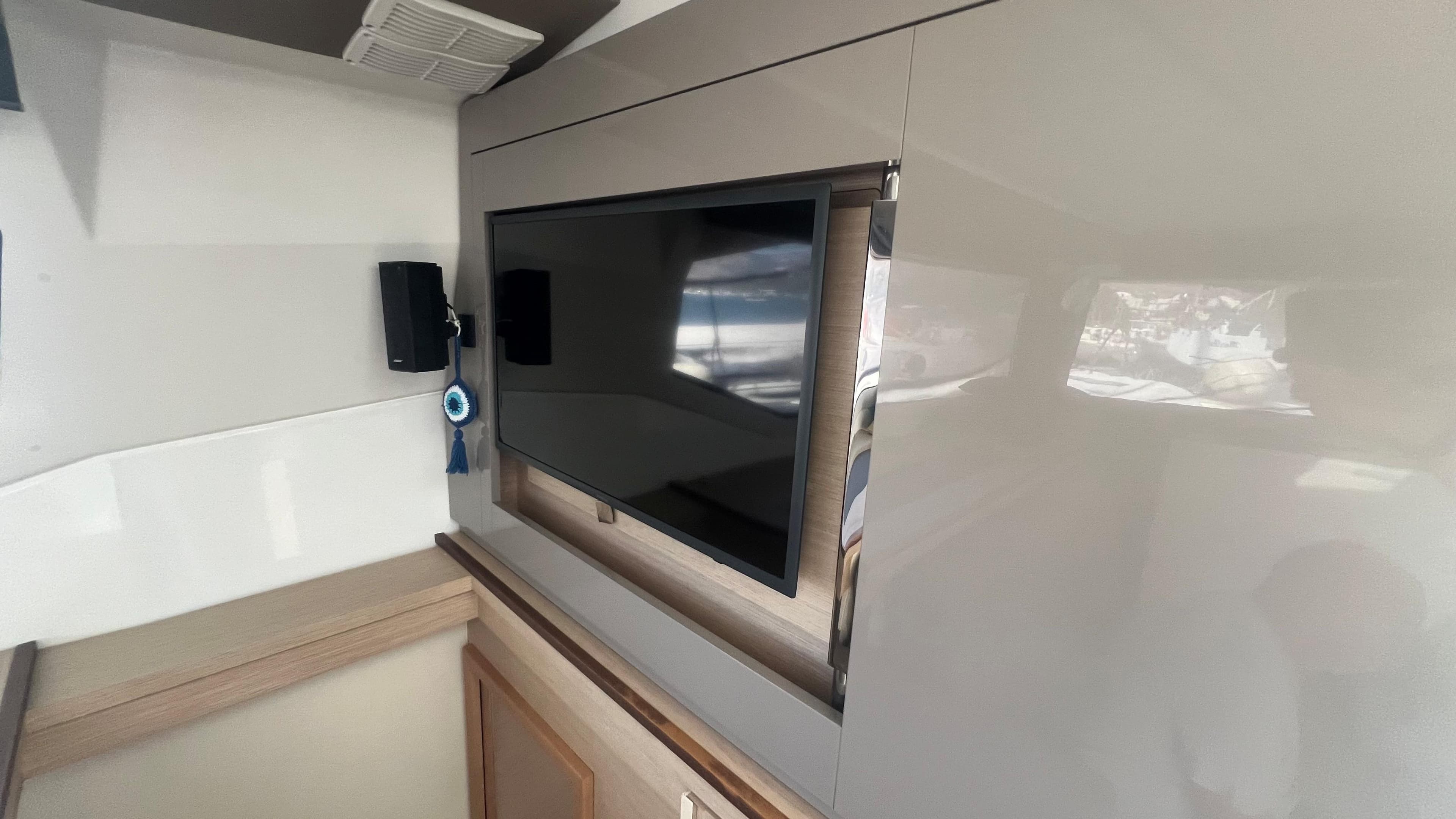 Interior of 2018 Fountaine Pajot Saona 47 yacht with mounted TV and modern design.