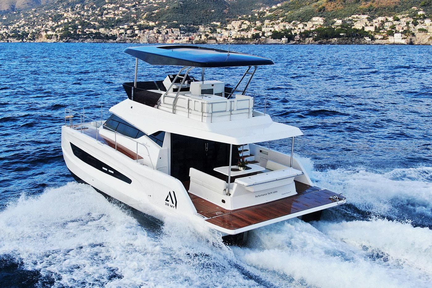 2026 Aventura 38 Motor Yacht cruising on blue ocean near scenic coastline.