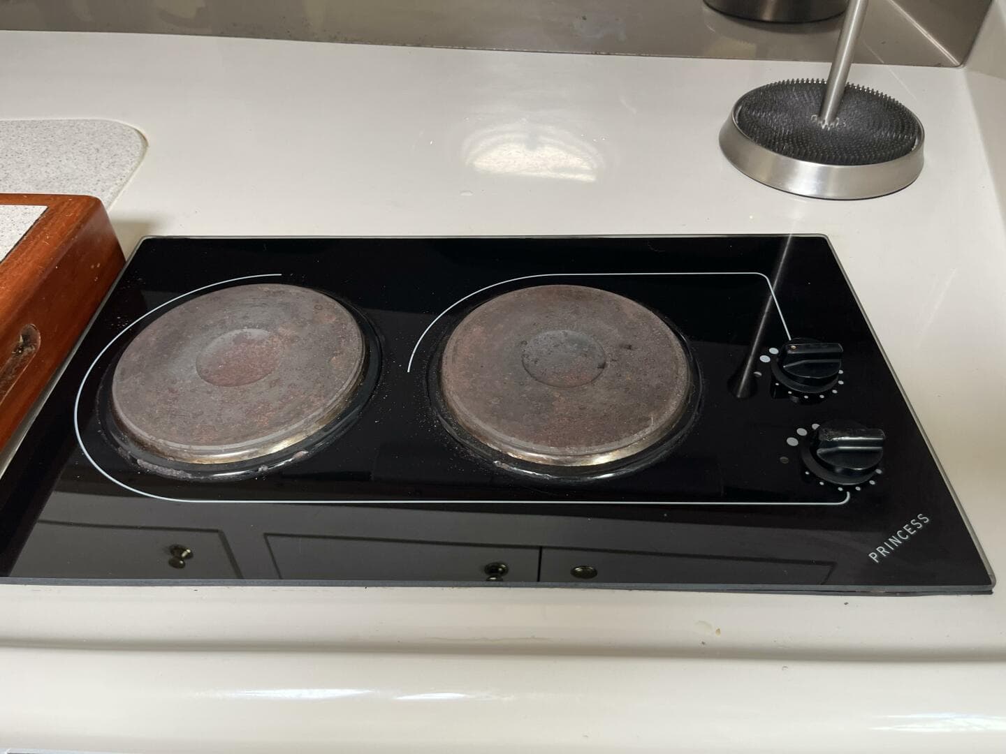 Electric stove on 1998 Cruisers Yachts 3870 Esprit, featuring dual burners and control knobs.