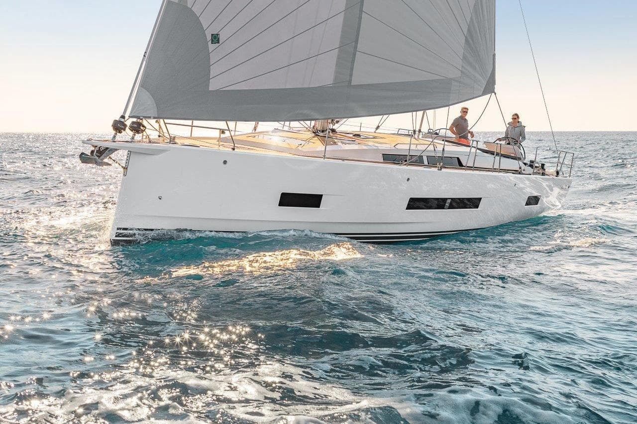 Sailing yacht Hanse 460, 2026 model, gliding on open sea with two people onboard.