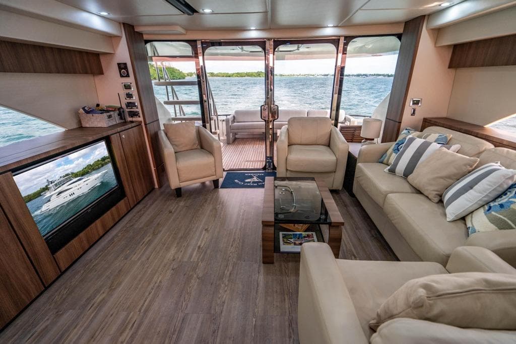 Luxurious interior of 2020 Fairline 68 yacht with elegant seating and scenic ocean view.