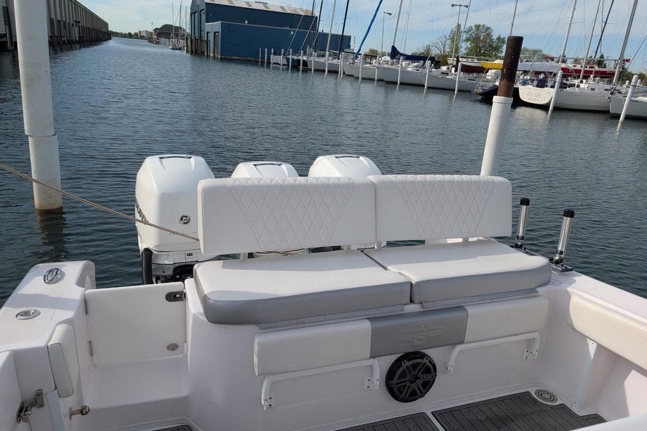 2018 Fountain 38 Center Console boat with triple engines docked at marina.