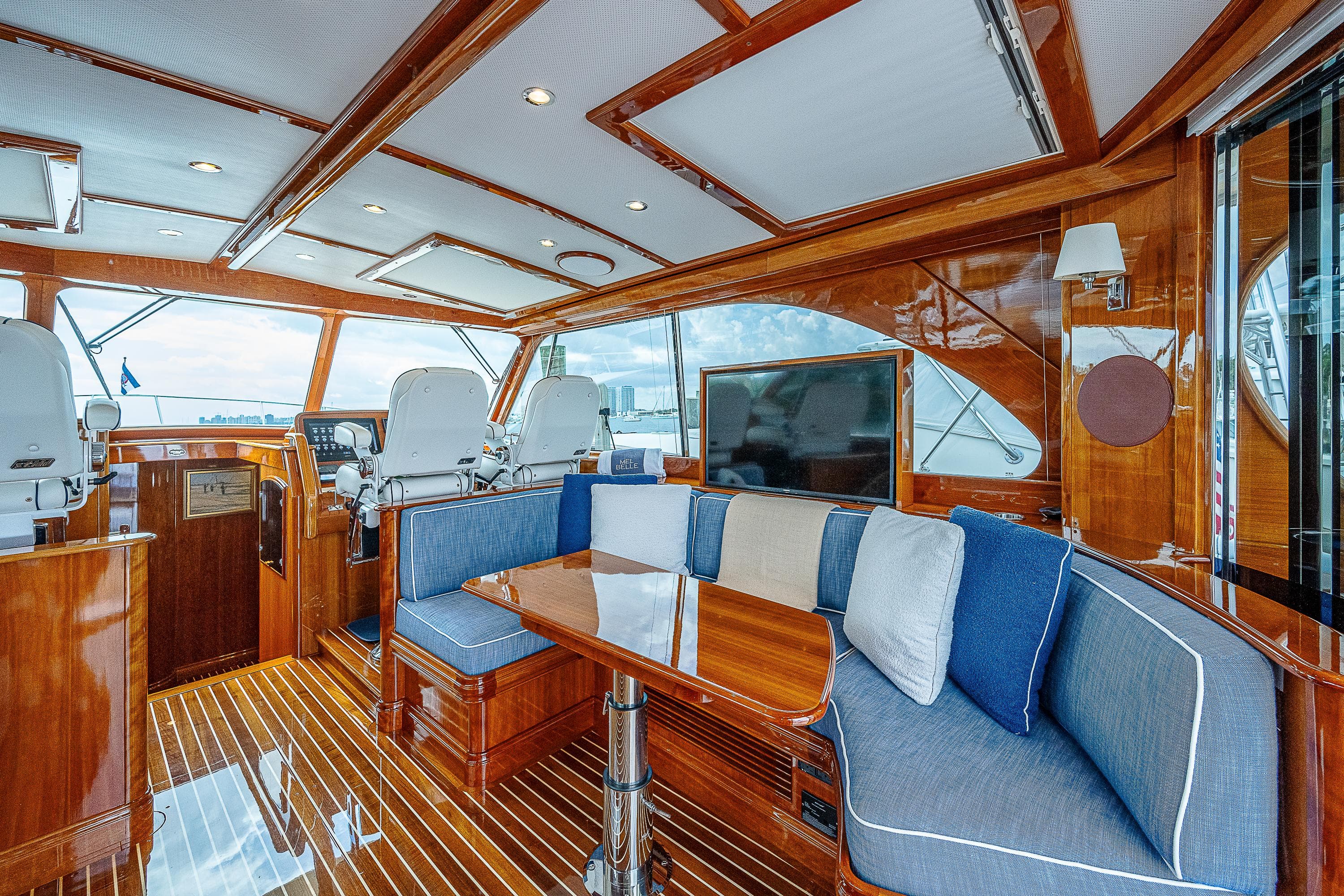 Luxurious 2018 Hinckley Talaria 55 MKII MY yacht interior with elegant wood finish and plush seating.