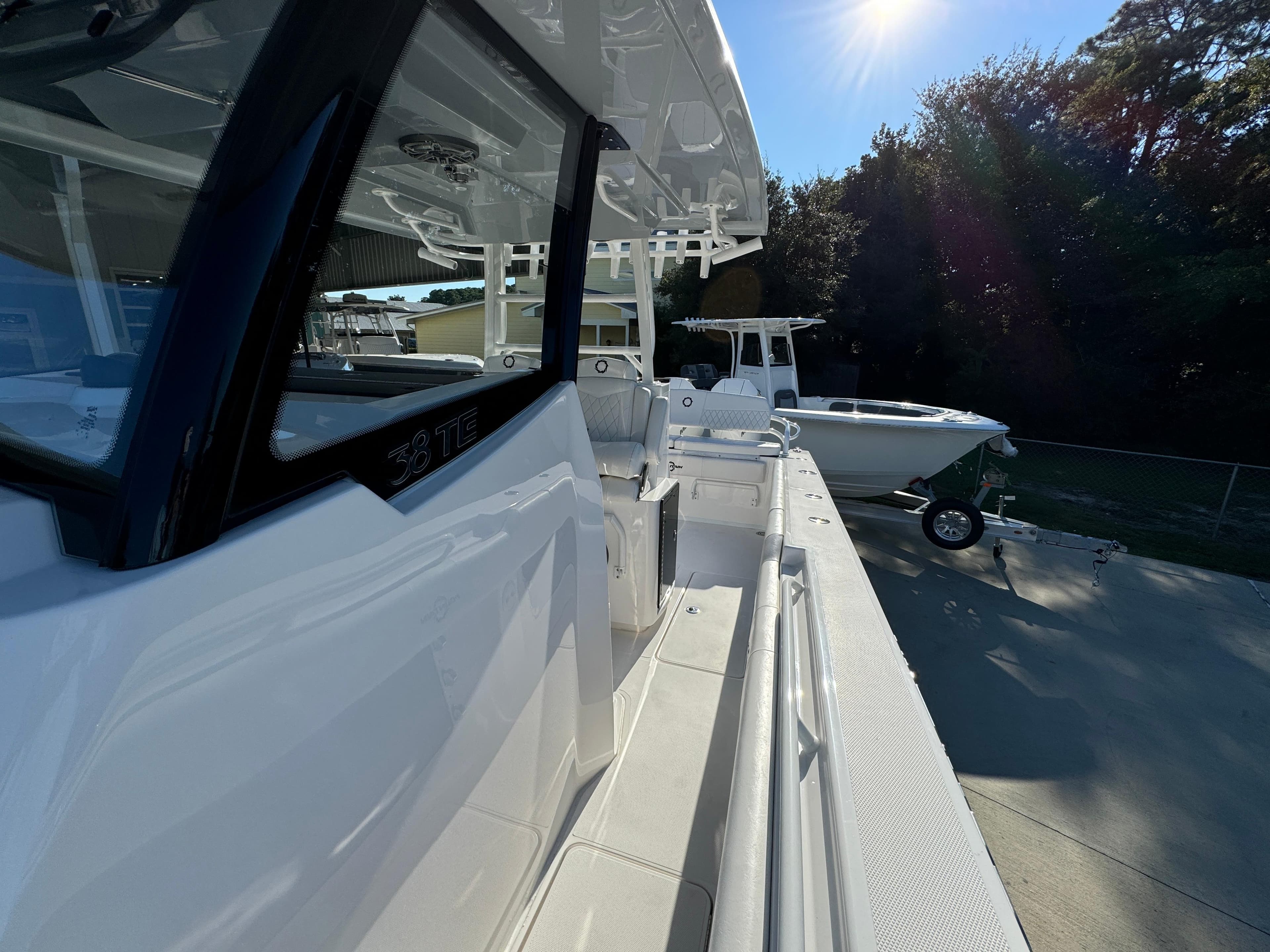 2025 Fountain 38TE boat docked under sunlight, showcasing sleek design and modern features.
