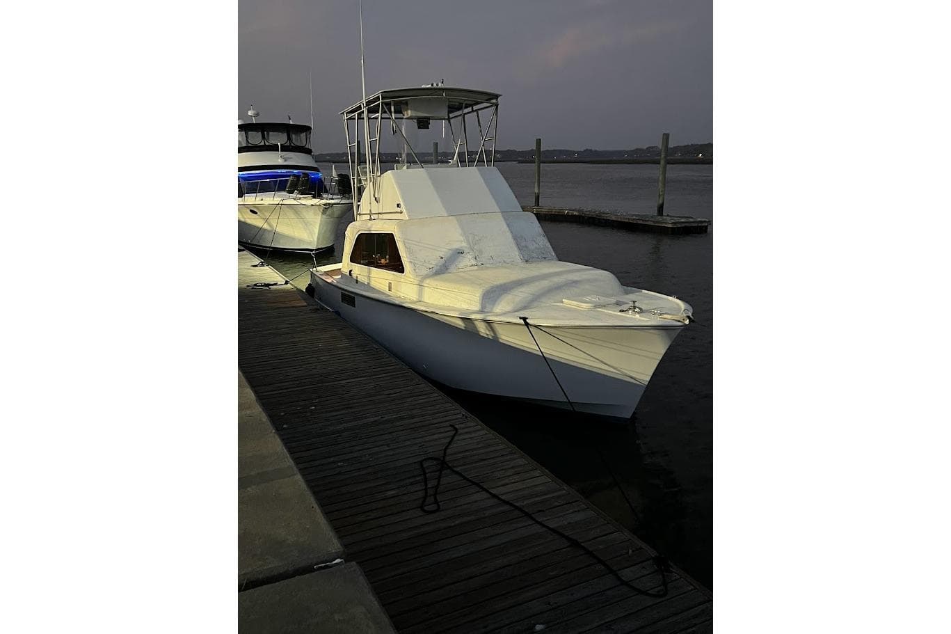 1963 Hatteras 34 Convertible yacht docked at sunset.