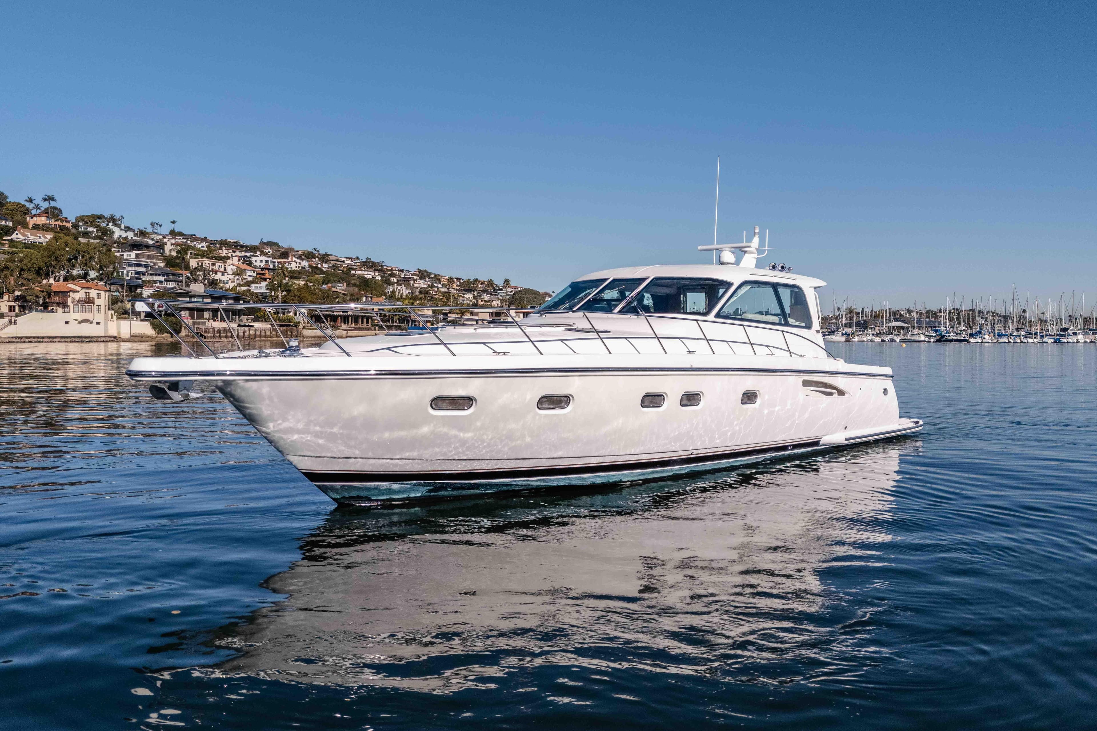2006 Tiara Yachts 5200 Sovran Salon cruising on calm waters near a coastal town.