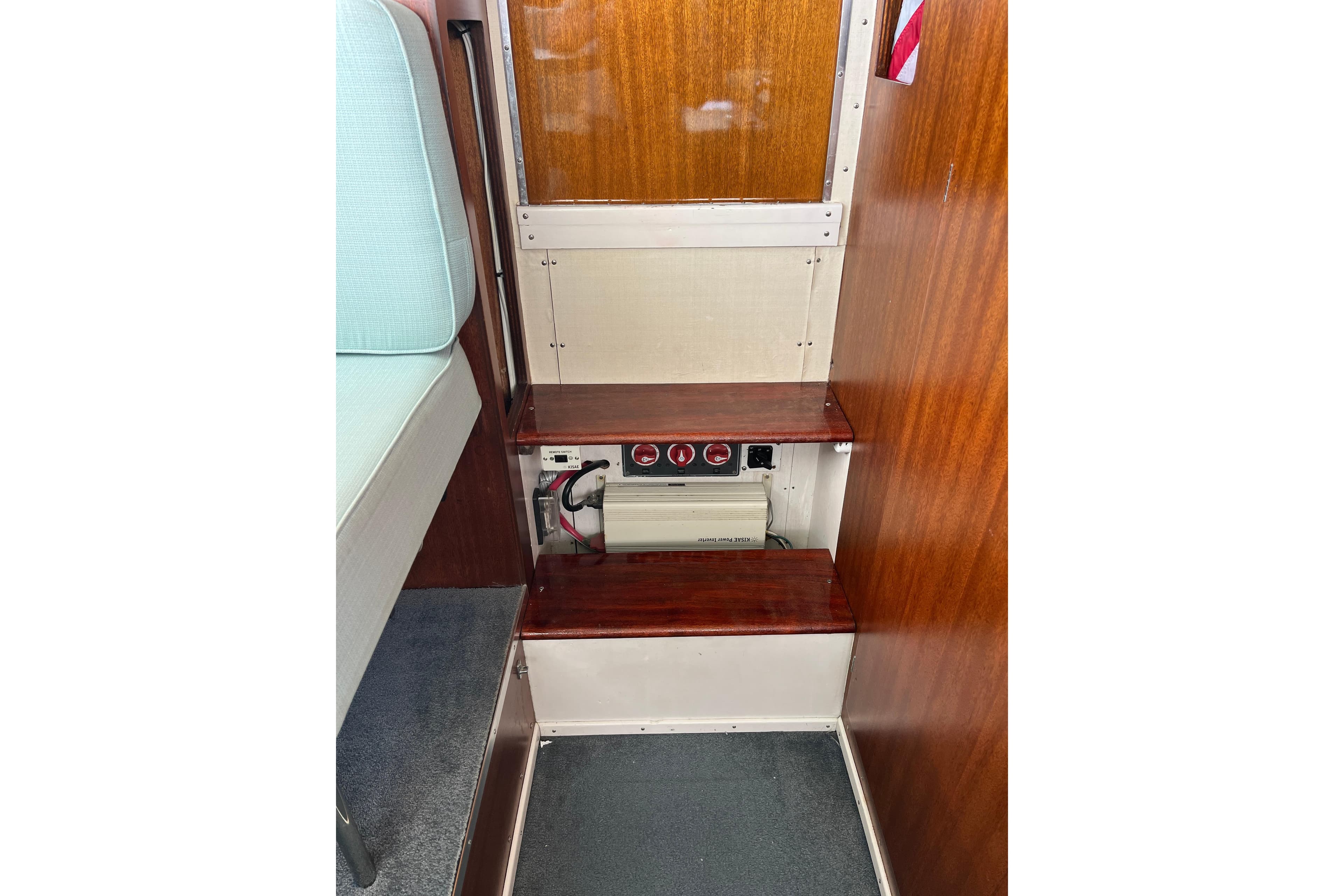 Interior of 1966 Chris-Craft 27 Commander showing wooden steps and electrical panel.