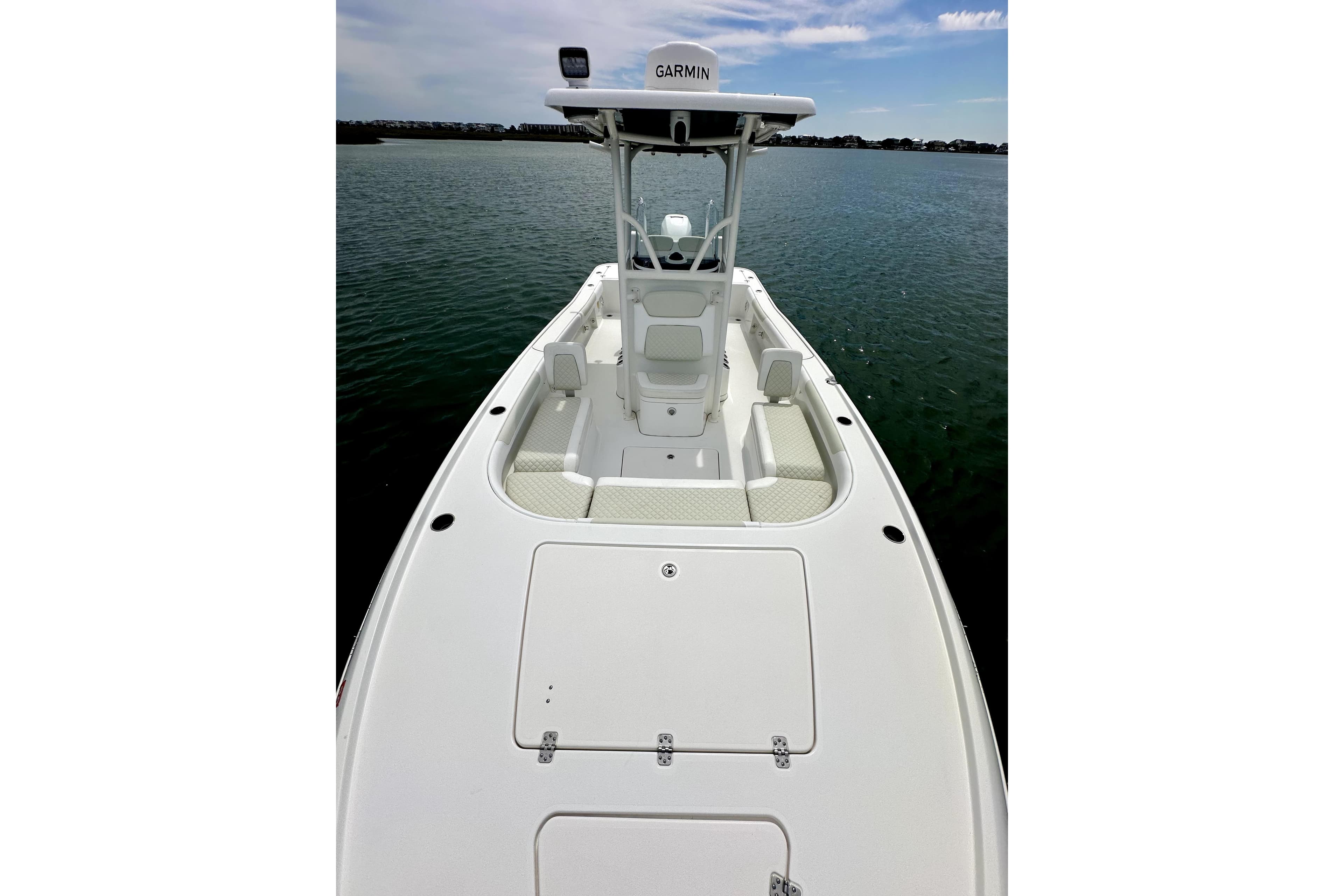 2020 Caymas 26 HB boat on calm water, featuring a sleek white deck and Garmin equipment.