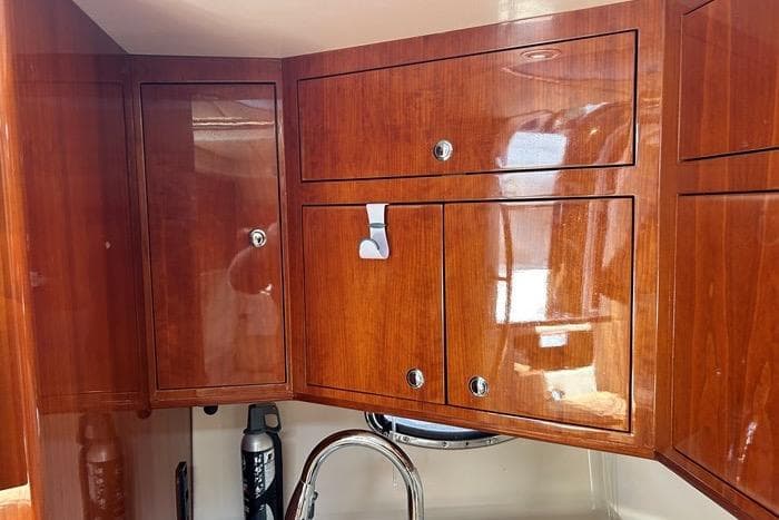 Wooden cabinets in a 2007 Regal Commodore 4060 yacht interior, featuring polished finish and modern fixtures.