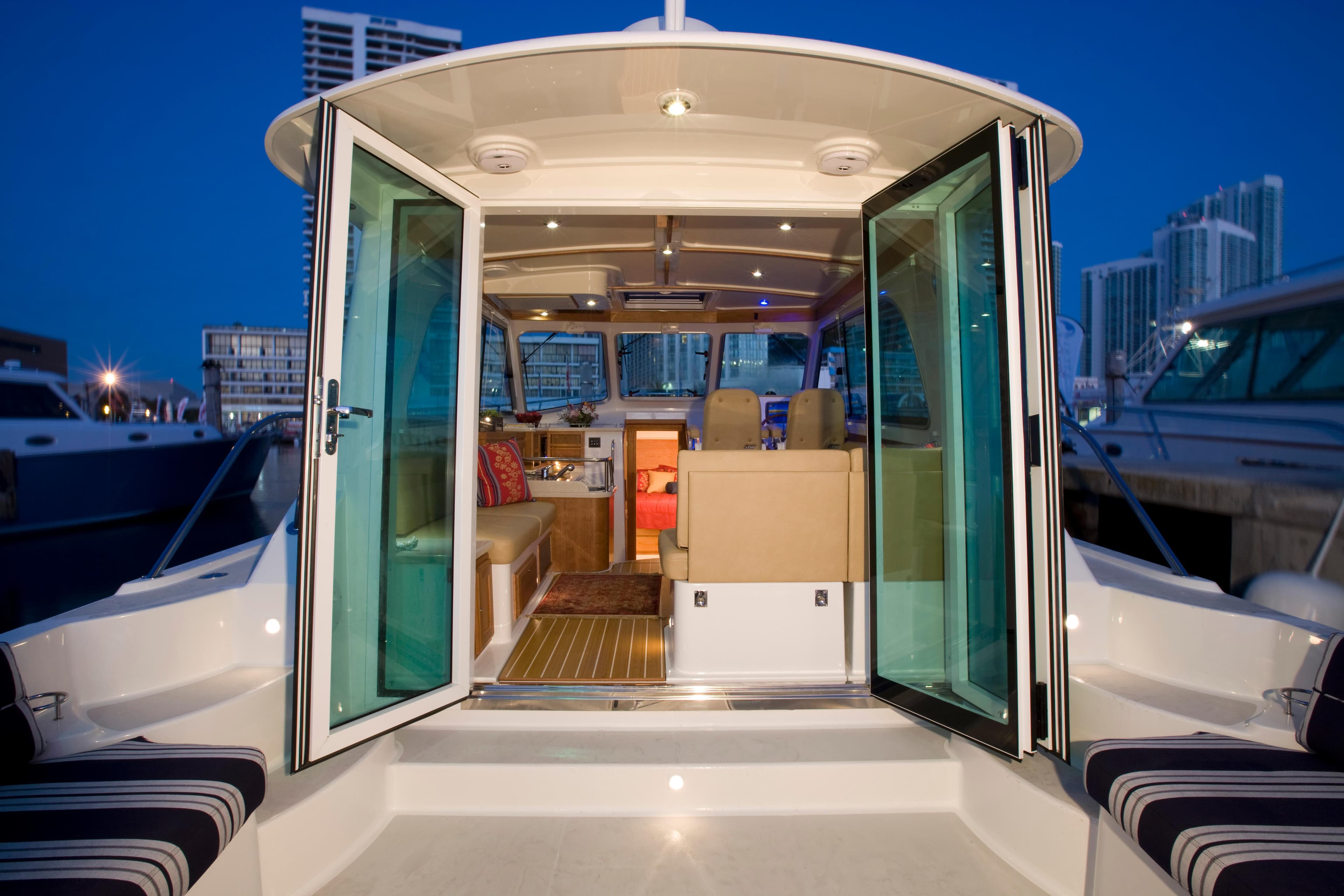 2026 Back Cove 372 yacht interior with open glass doors, docked at marina.